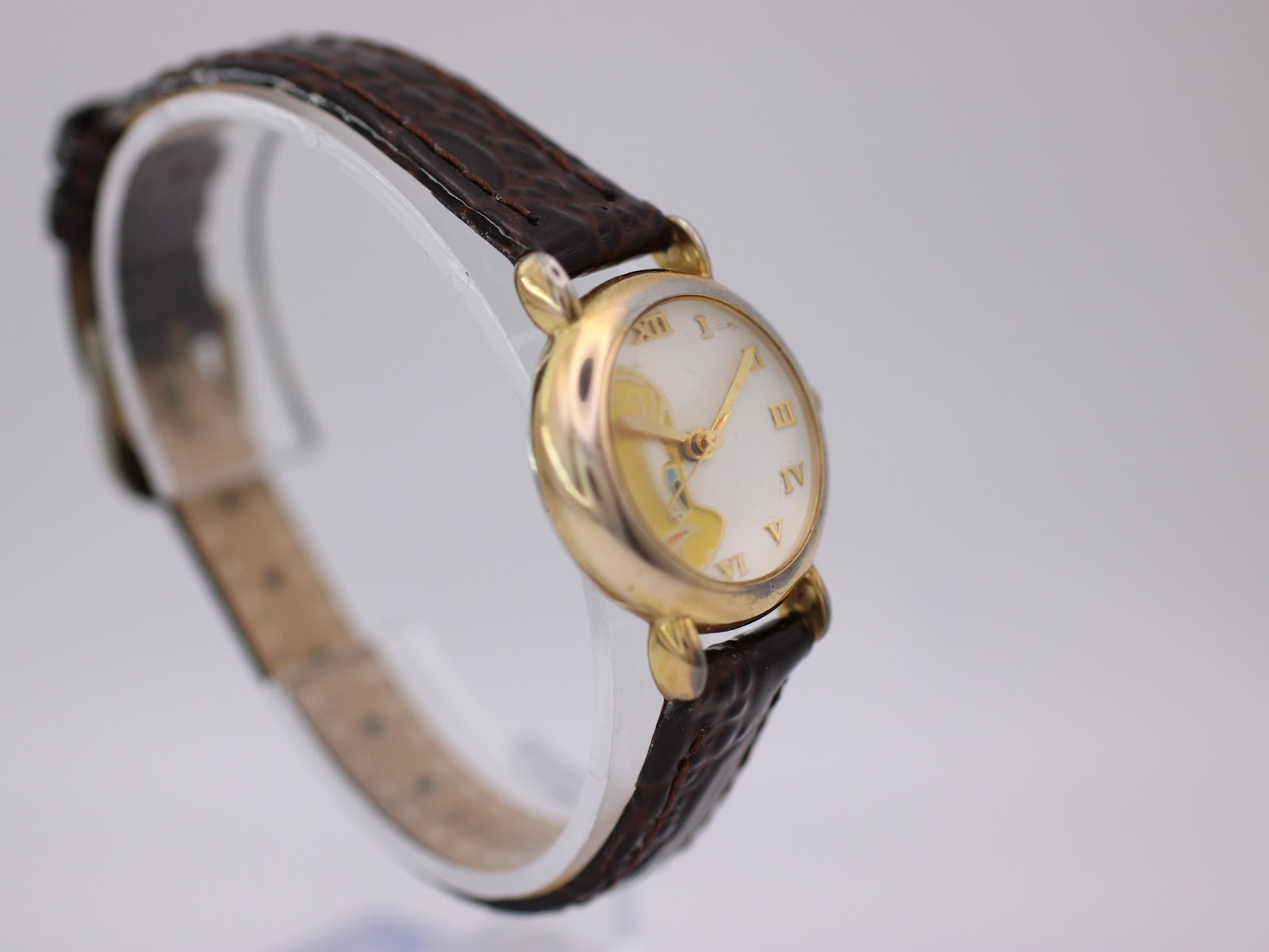 Another angled view of the Tweety Bird watch, highlighting the white dial with Roman numerals and the gold-tone case.