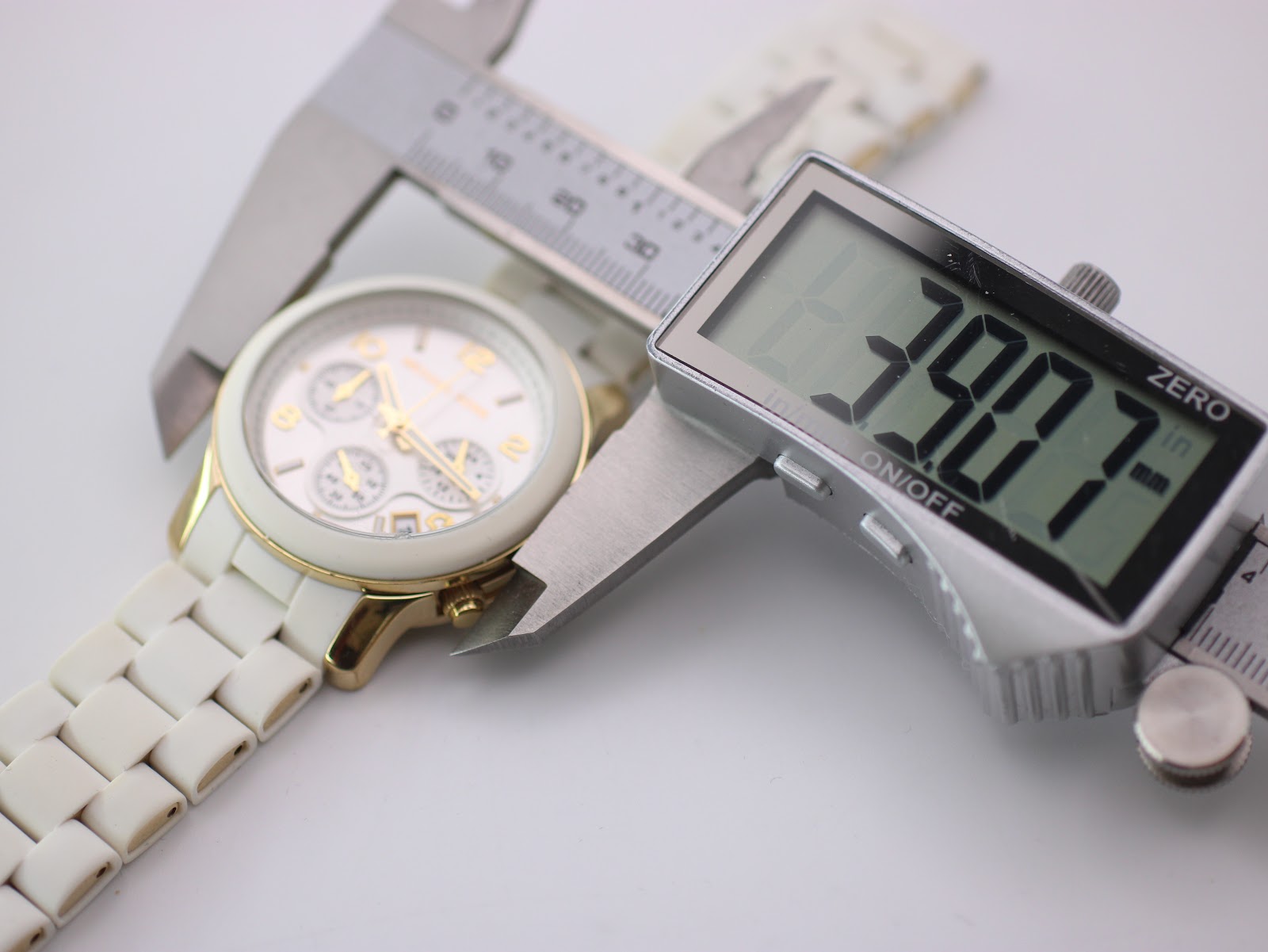 Digital caliper measuring the case diameter of the watch, displaying a precise reading of 38.7mm.