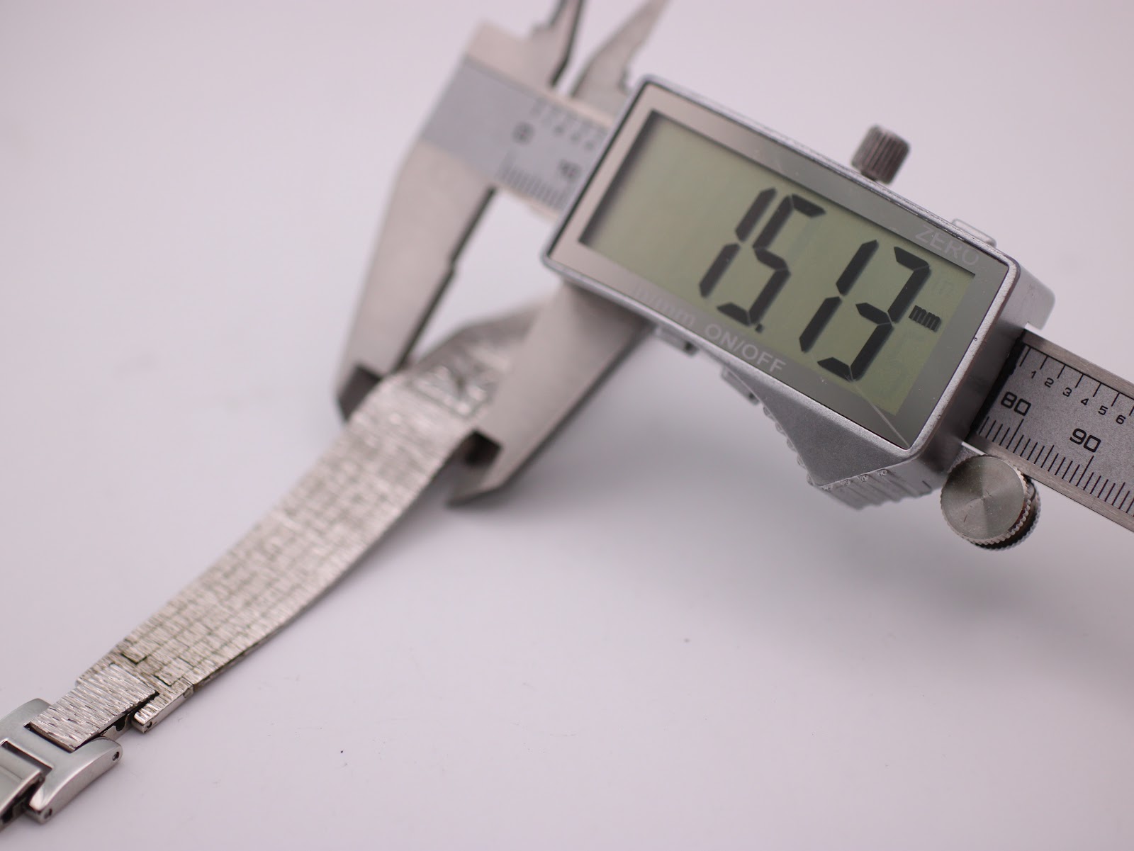 Digital caliper measuring the bracelet width at 15.13mm.