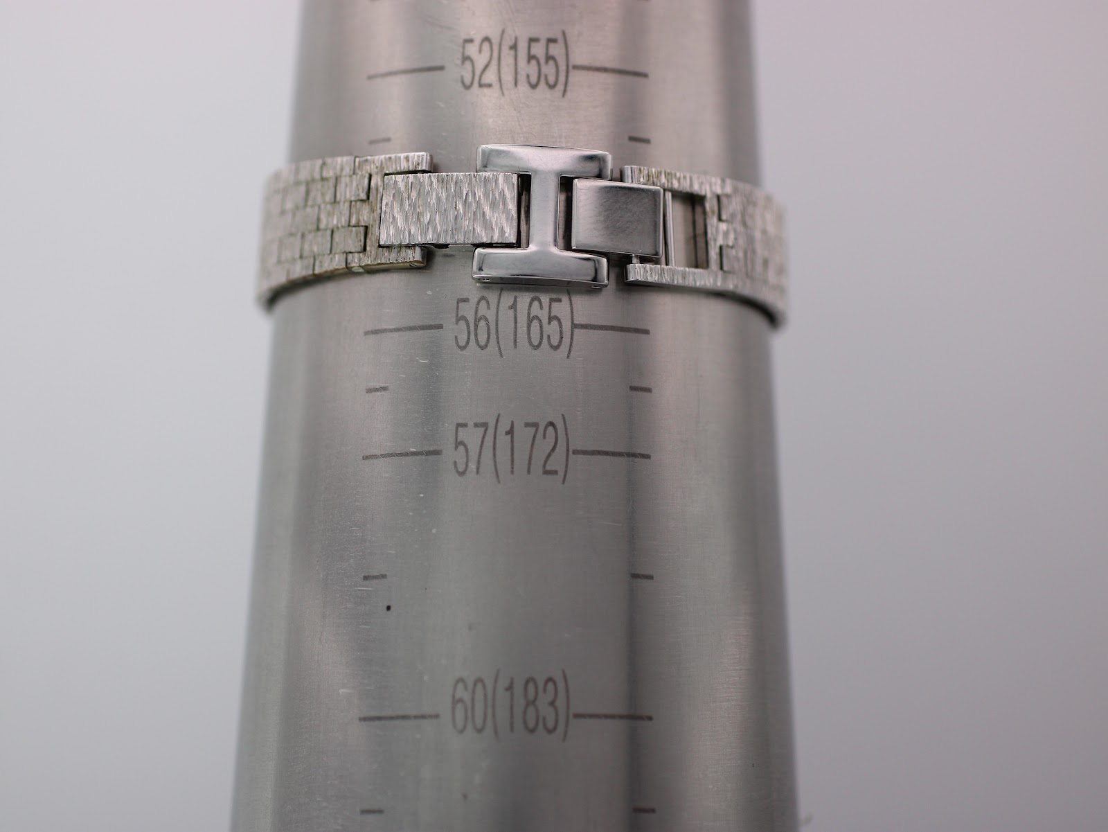 Watch bracelet on a wrist sizing cone, showing a wrist circumference of approximately 16.5cm.