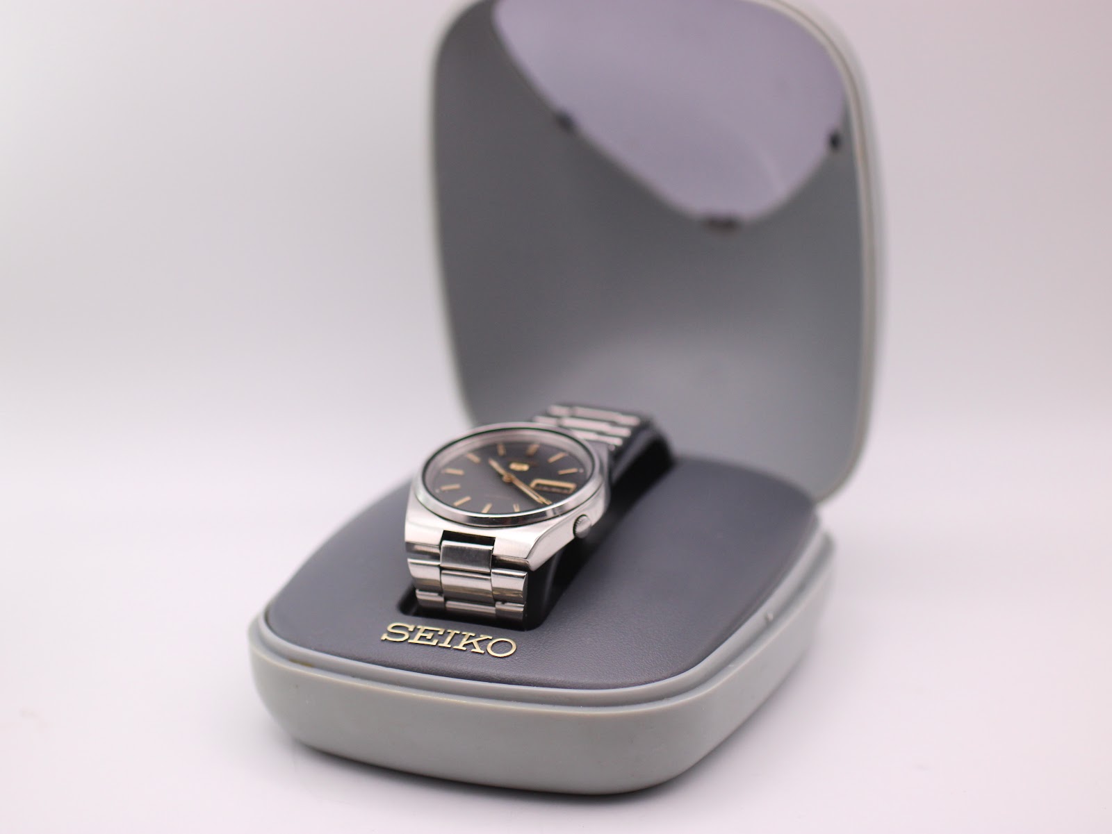 The Seiko 7009-3130 watch displayed in its original grey clam-shell presentation box.