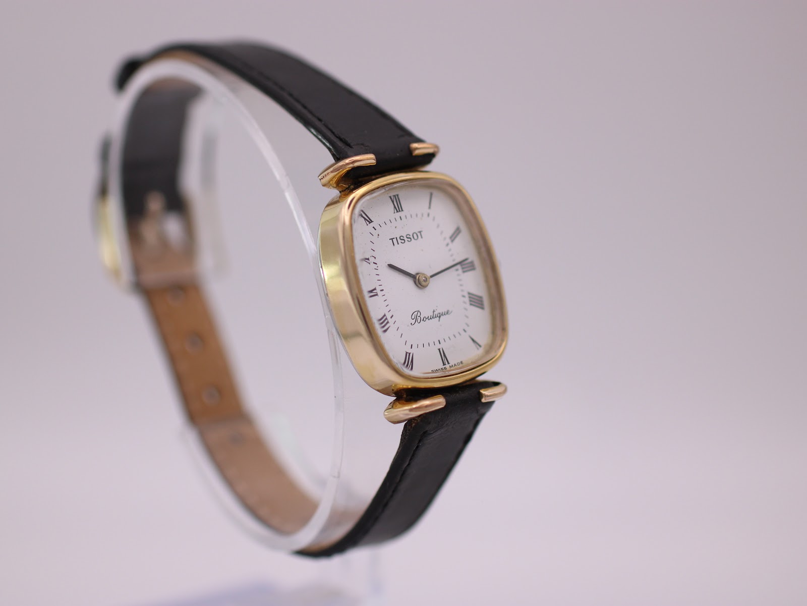 Another angled side view of the Tissot Boutique watch, highlighting the profile of the case and strap.