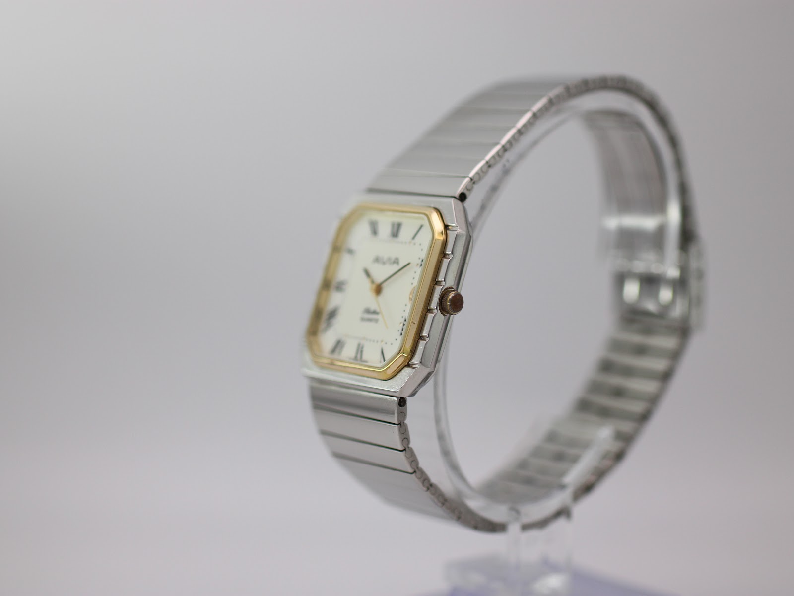 Side profile view of the AVIA Flatline watch on a display stand, showing the two-tone case and crown.