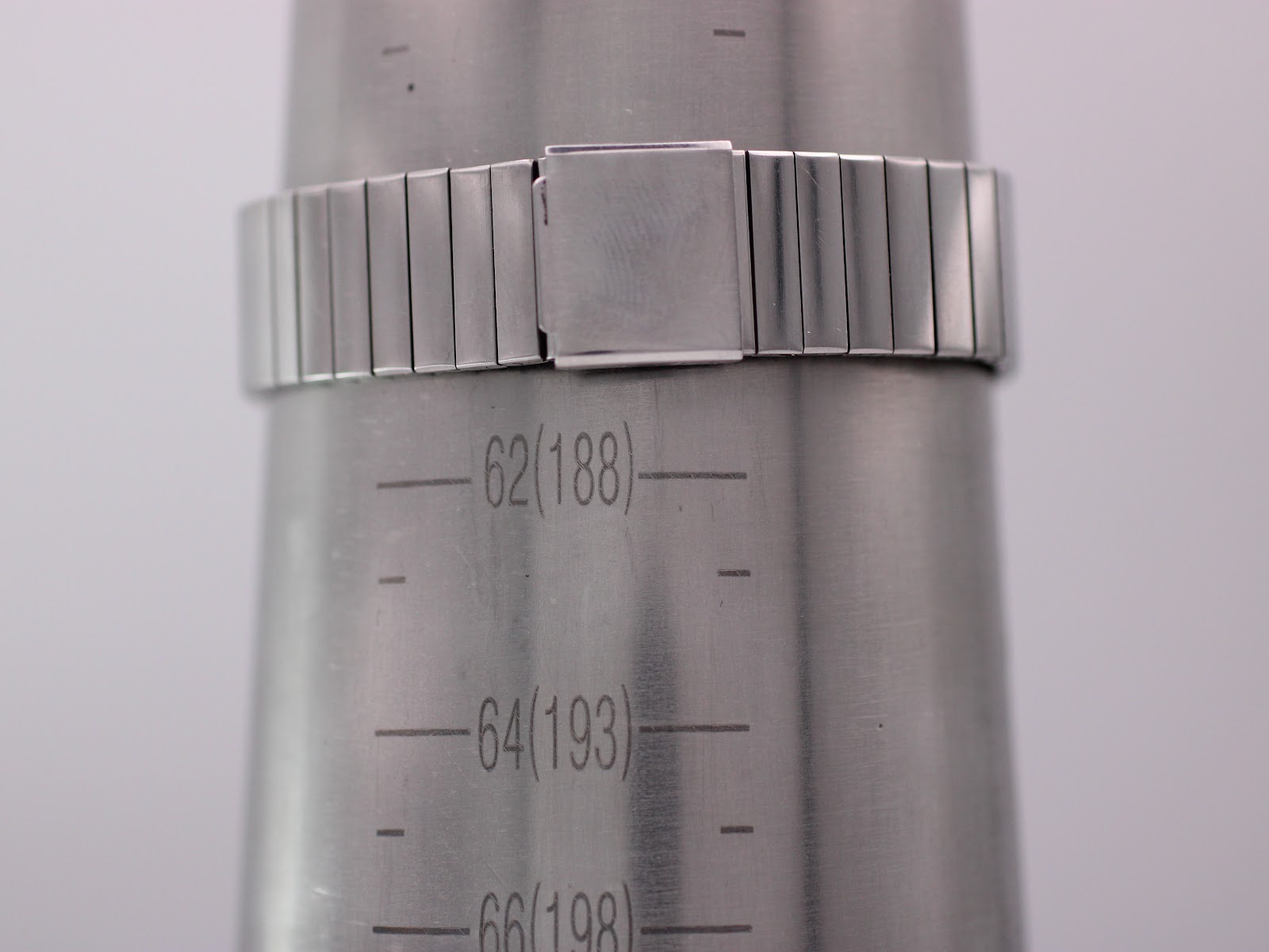 Wrist sizing gauge showing the stainless steel expansion bracelet wrapped around, indicating a wrist size of approximately 18.8cm (188mm).
