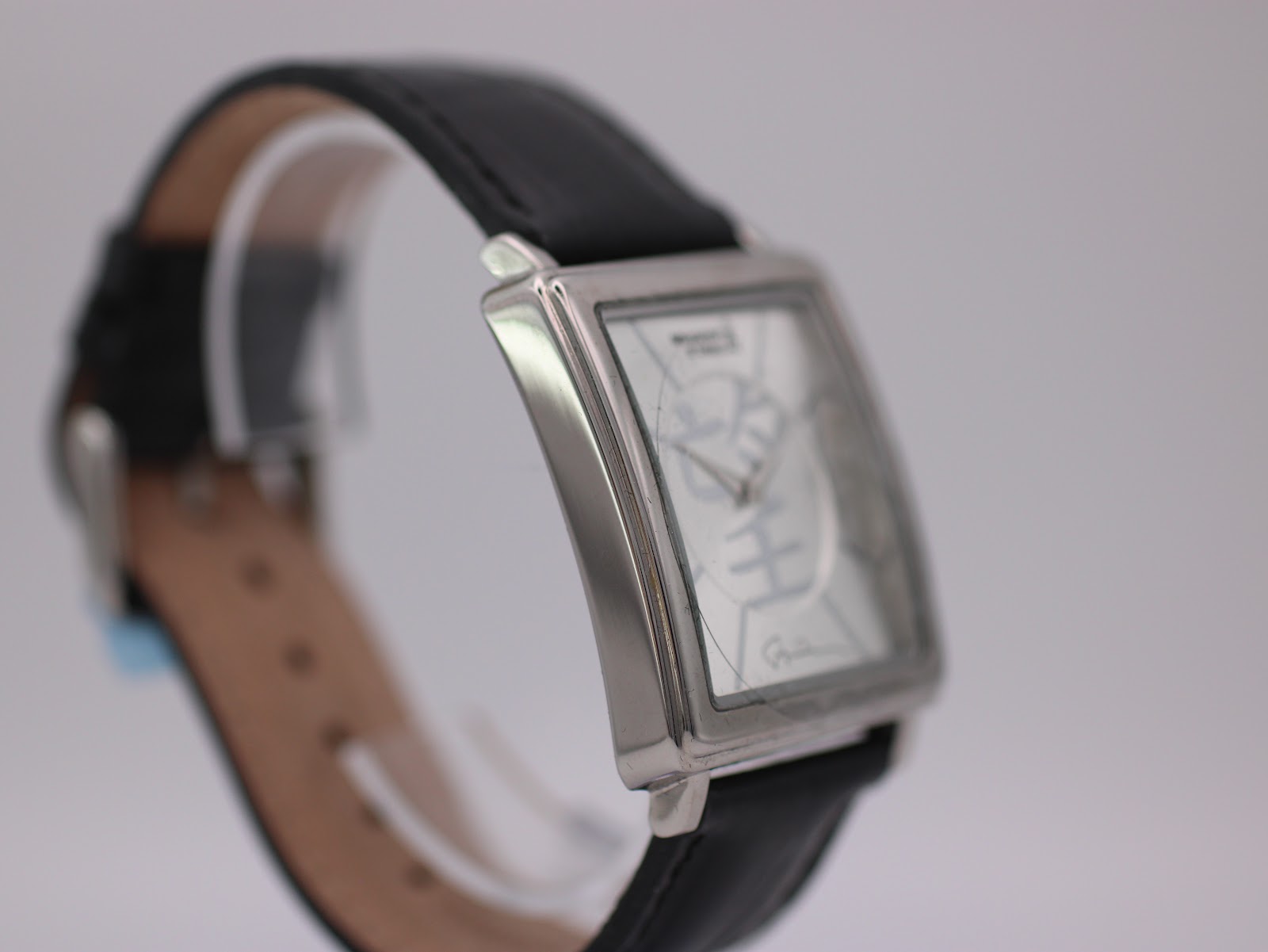 Angled side view of the Giorgio Armani watch, showing the polished silver-tone case and crown.