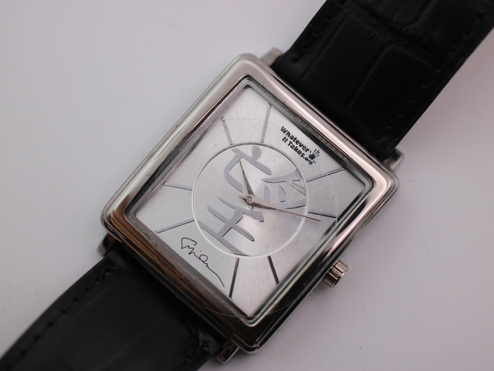 Side profile of the Giorgio Armani square watch case with curved lugs.