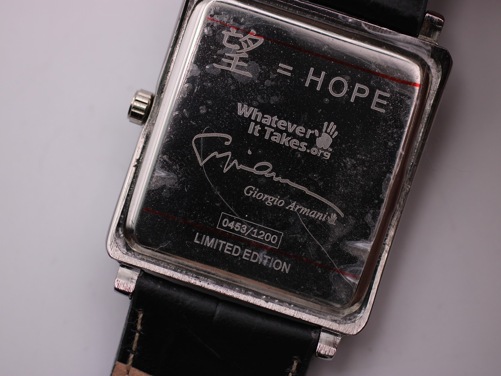 Close-up of the case back engraving, showing serial number 0453/1200, 'Hope' character, and 'Whatever It Takes.org'.