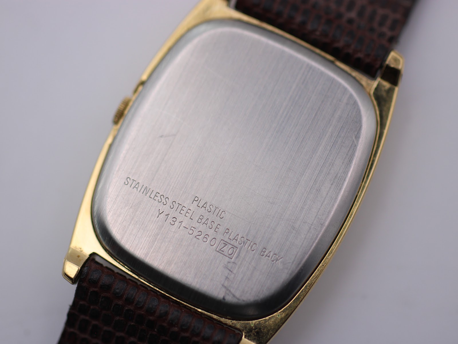 Close-up of the stainless steel case back of the Lorus watch, engraved with 'STAINLESS STEEL BASE PLASTIC PLASTIC BACK' and model number 'Y131-5260 ZO'.