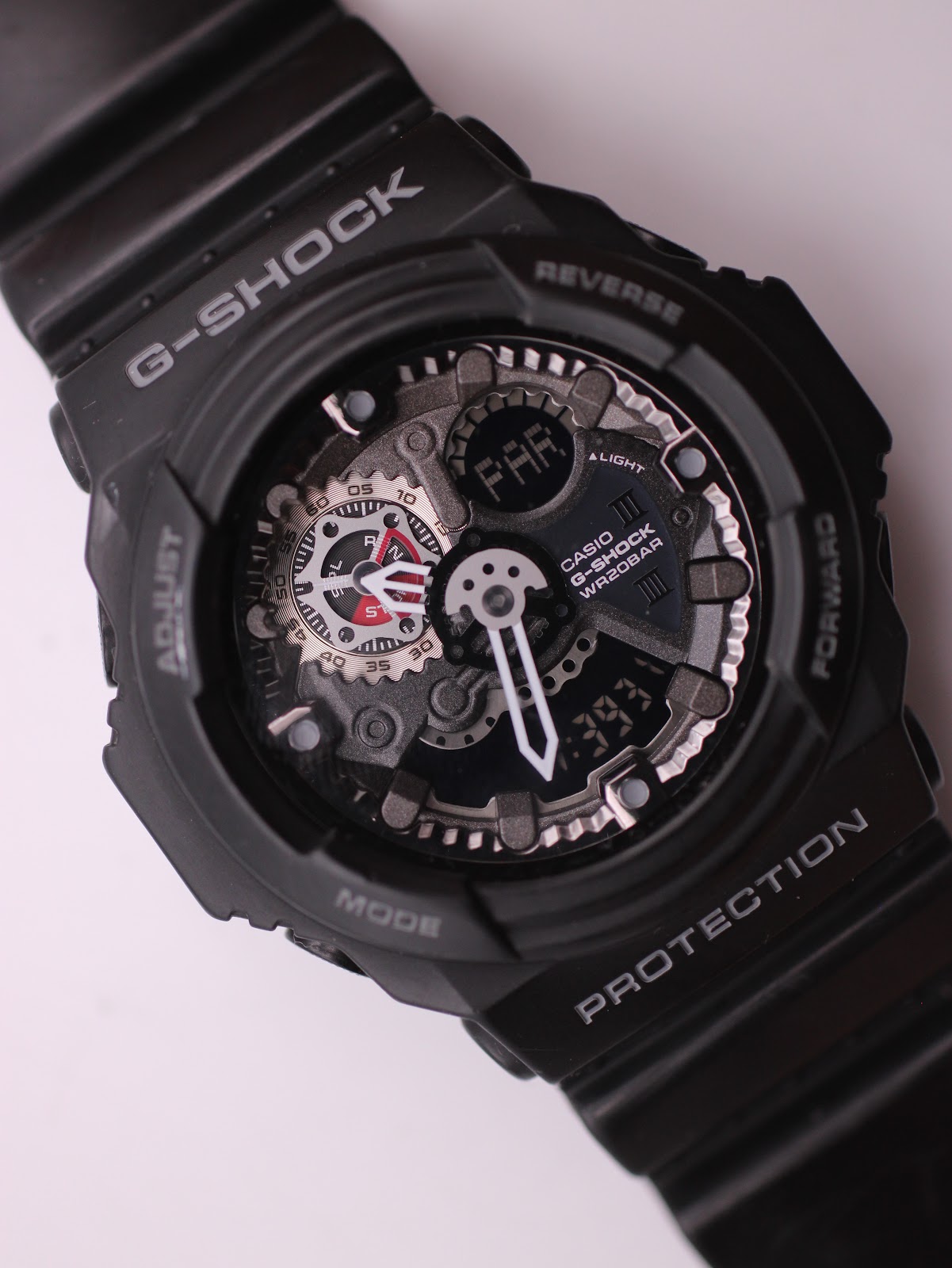 Close-up top-down view of the G-SHOCK GA-300 dial, showing the ana-digi display, visible gear-like elements, and red accents.