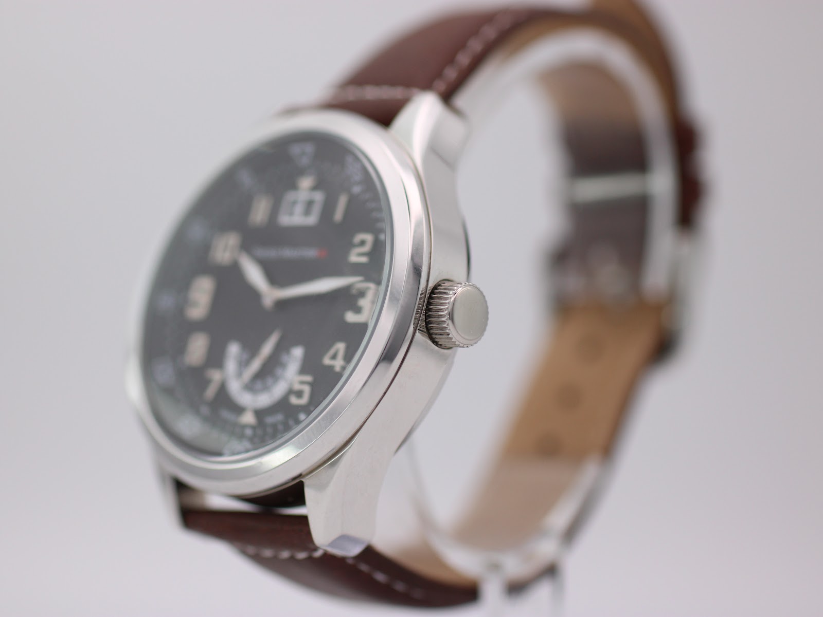 Angled side view of the Swiss Master watch, highlighting the polished stainless steel case and crown.