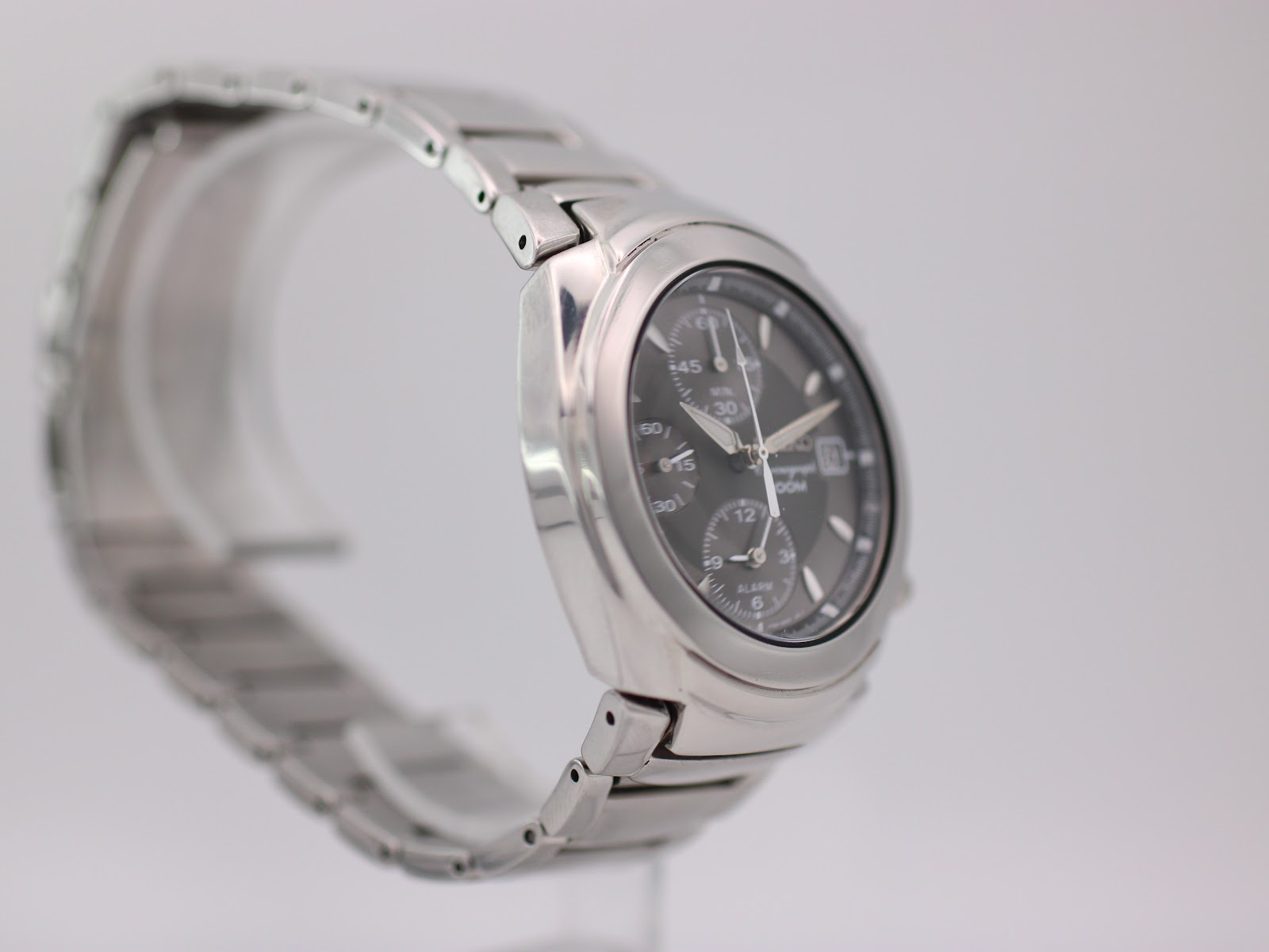 Another side-angle view of the Seiko watch, focusing on the left profile and integrated bracelet design.