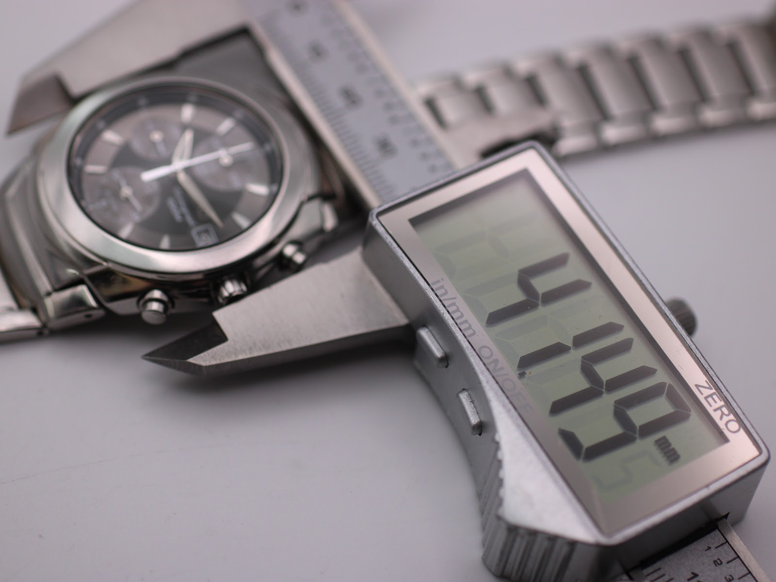Digital caliper measuring the case diameter as 41.44mm, with the Seiko watch in the background.