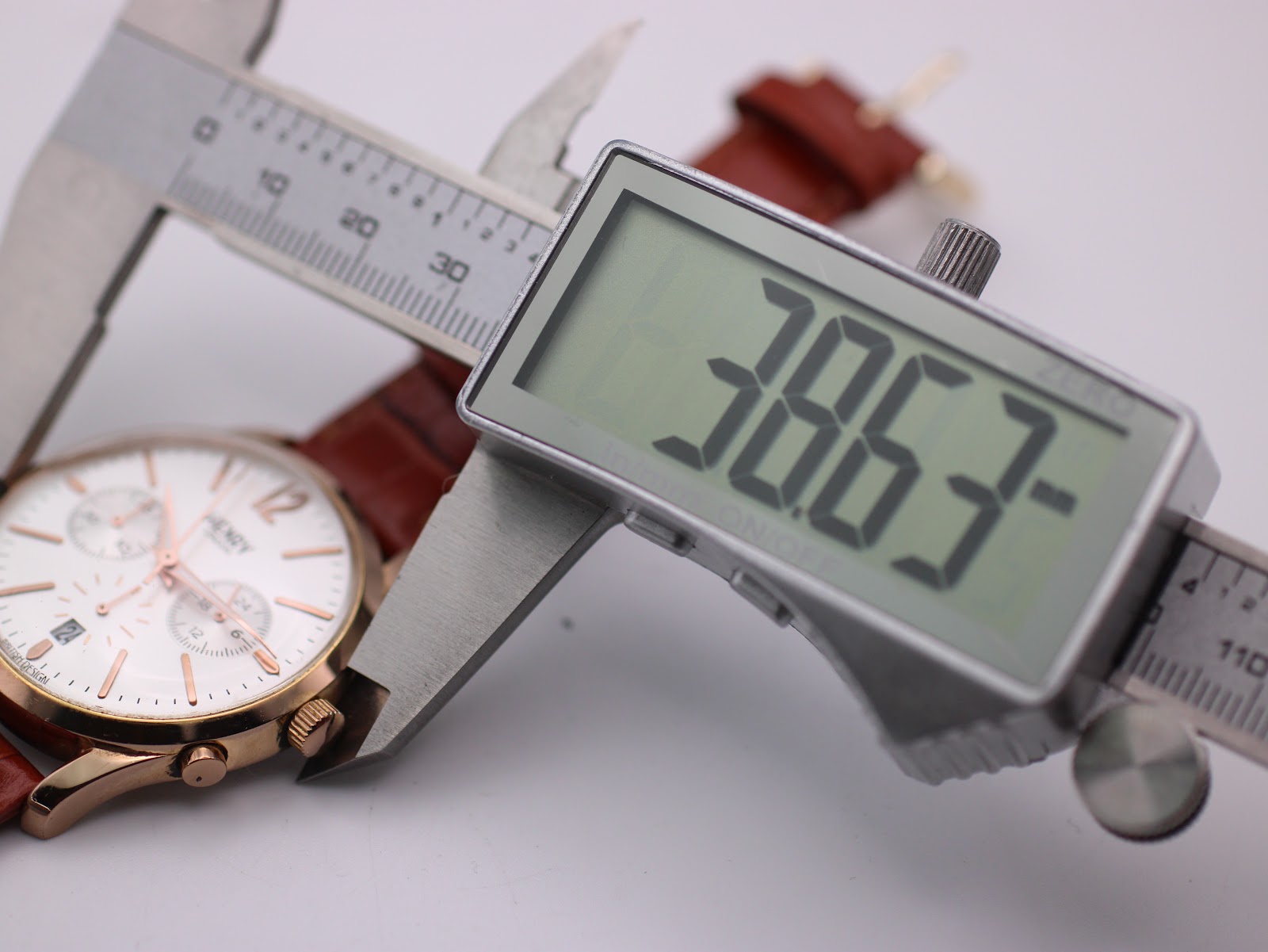 Digital caliper measuring the case diameter of the Henry London watch, displaying a precise measurement of 38.63mm.