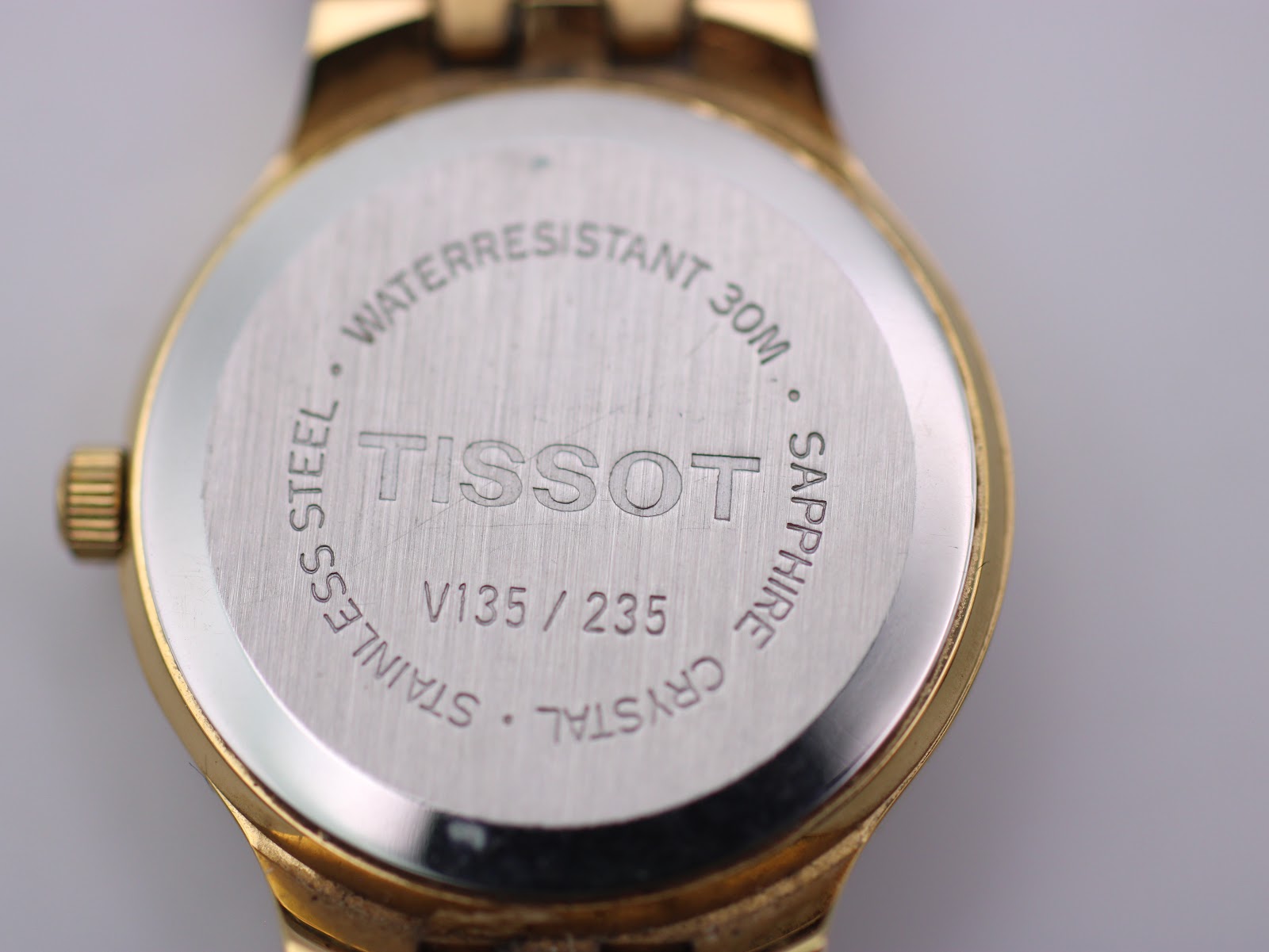 Close-up of the Tissot Stylist stainless steel case back, engraved with "WATERRESISTANT 30M" and "SAPPHIRE CRYSTAL".