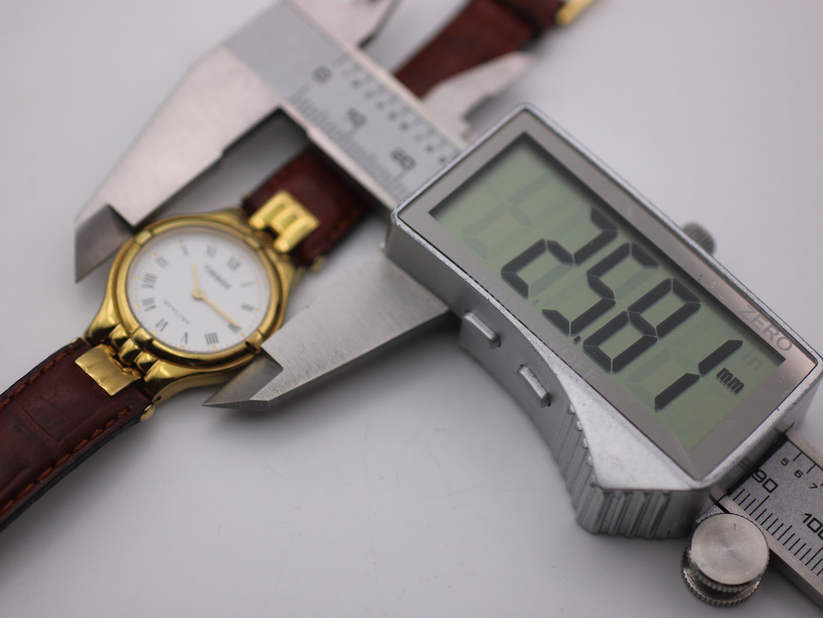 Digital calipers measuring the Tissot Stylist case diameter at 25.81mm.