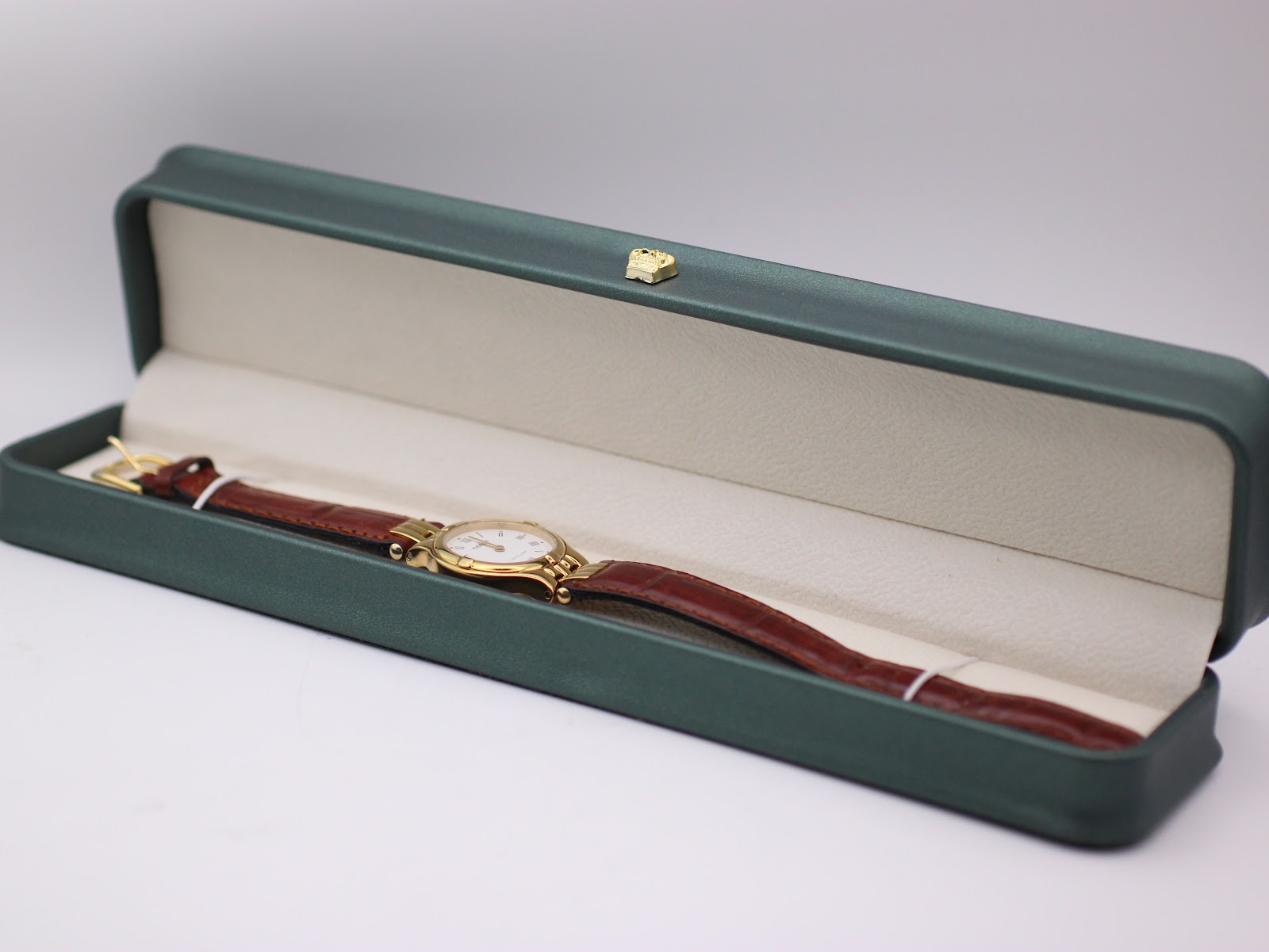 Tissot Stylist watch displayed within a generic green leatherette presentation box.