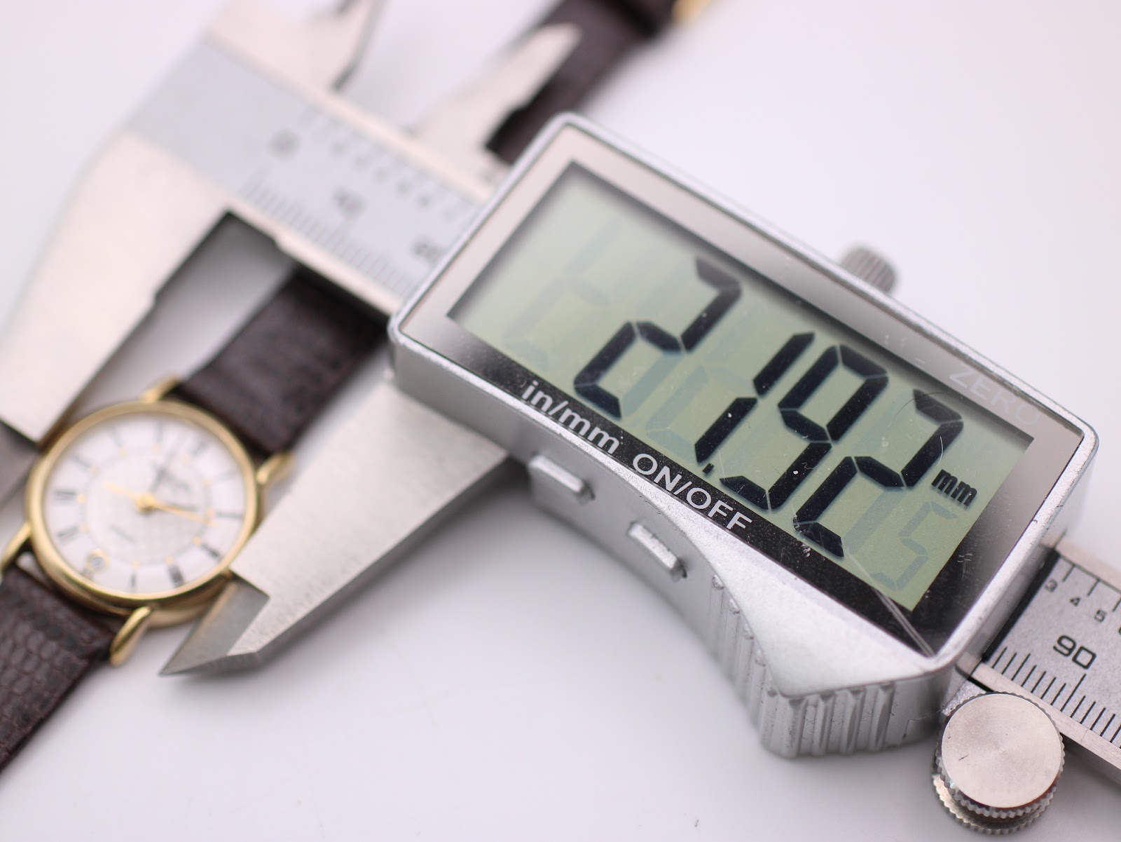 Digital caliper measuring the watch case diameter at 21.92mm.