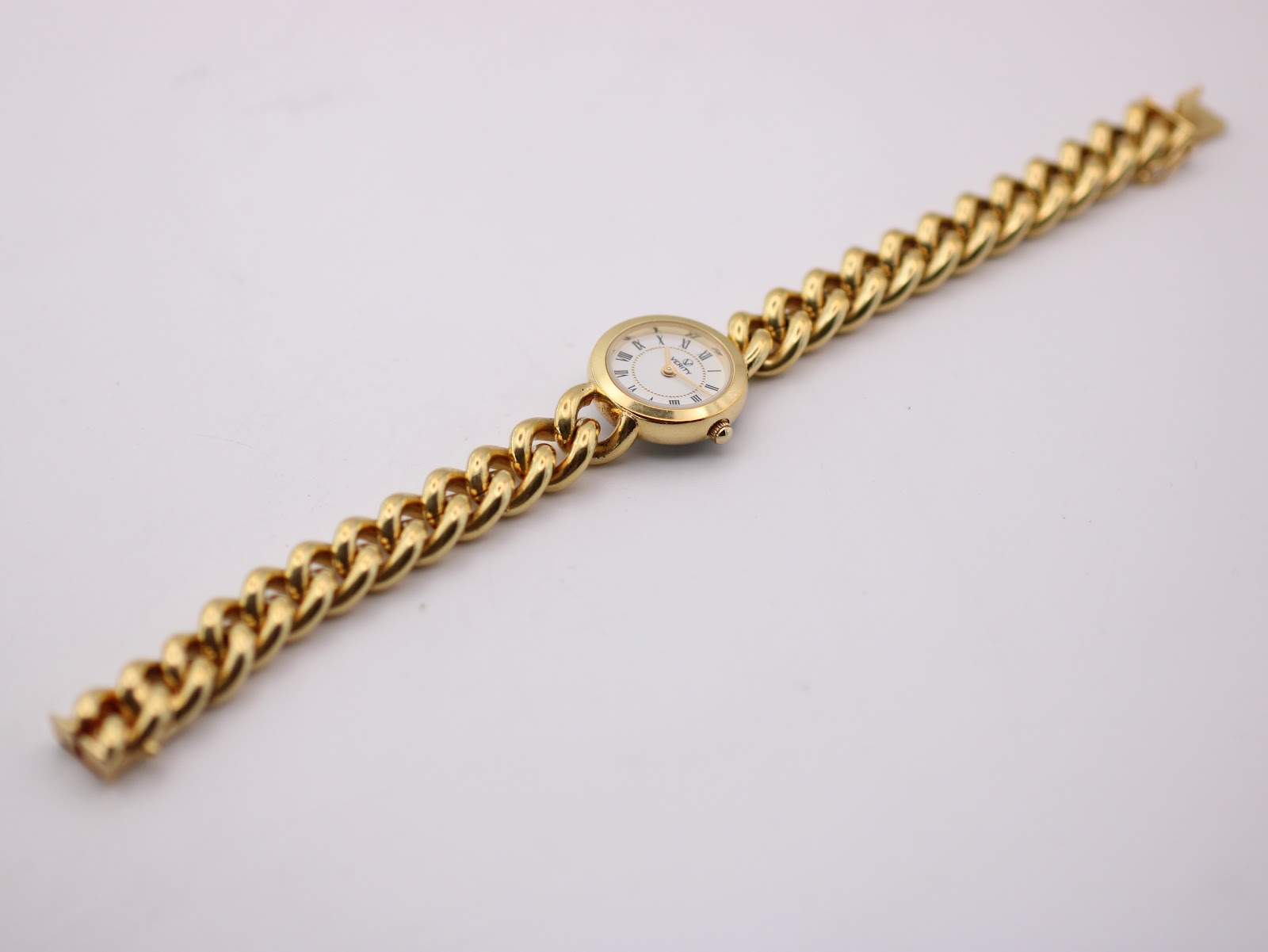 Top-down view of the entire Verity watch, displaying the gold-tone chain link bracelet extended flat.