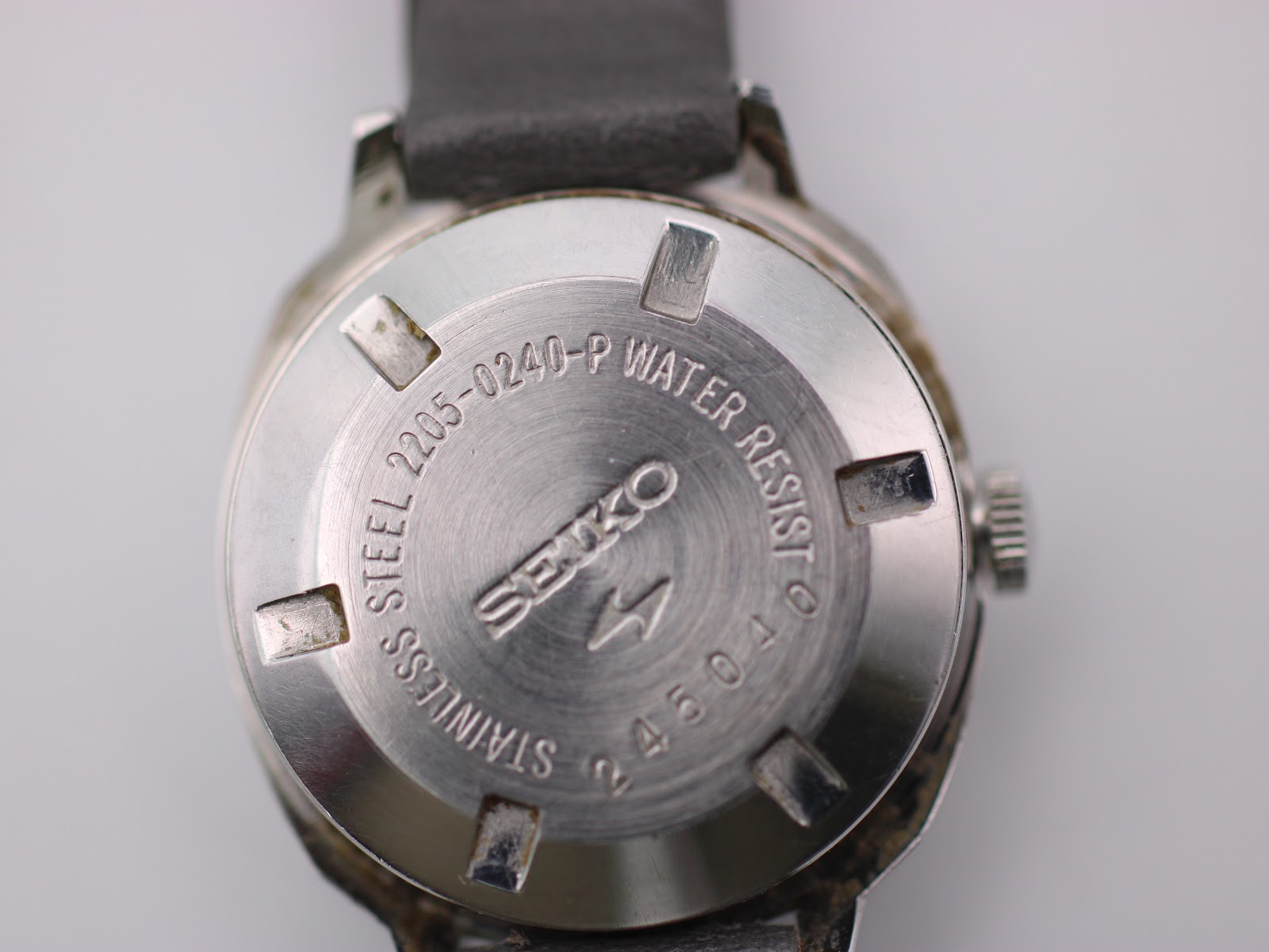 Close-up of the stainless steel case back of the Seiko 2205-0240-P, with engravings including the model number '2205-0240-P', 'WATER RESIST', and 'STAINLESS STEEL'.