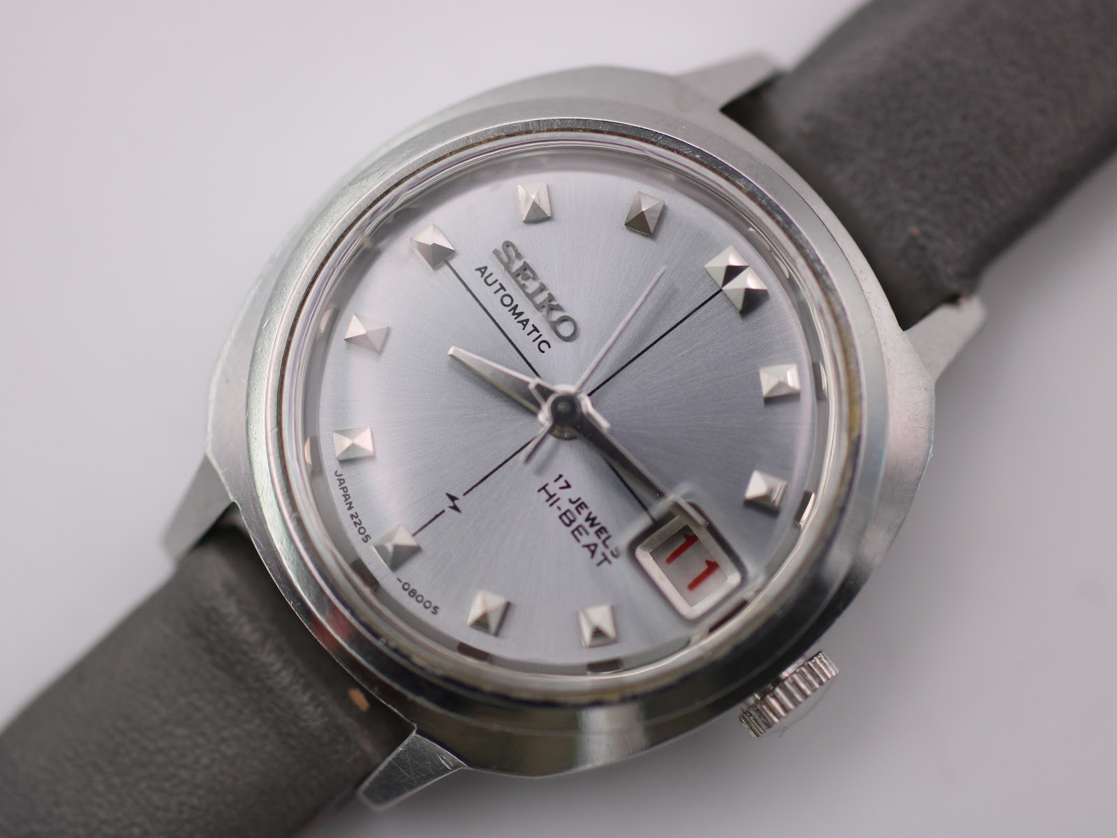 Another angled side view of the Seiko 2205-0240-P watch, showcasing the case profile and the lugs where the strap is attached.