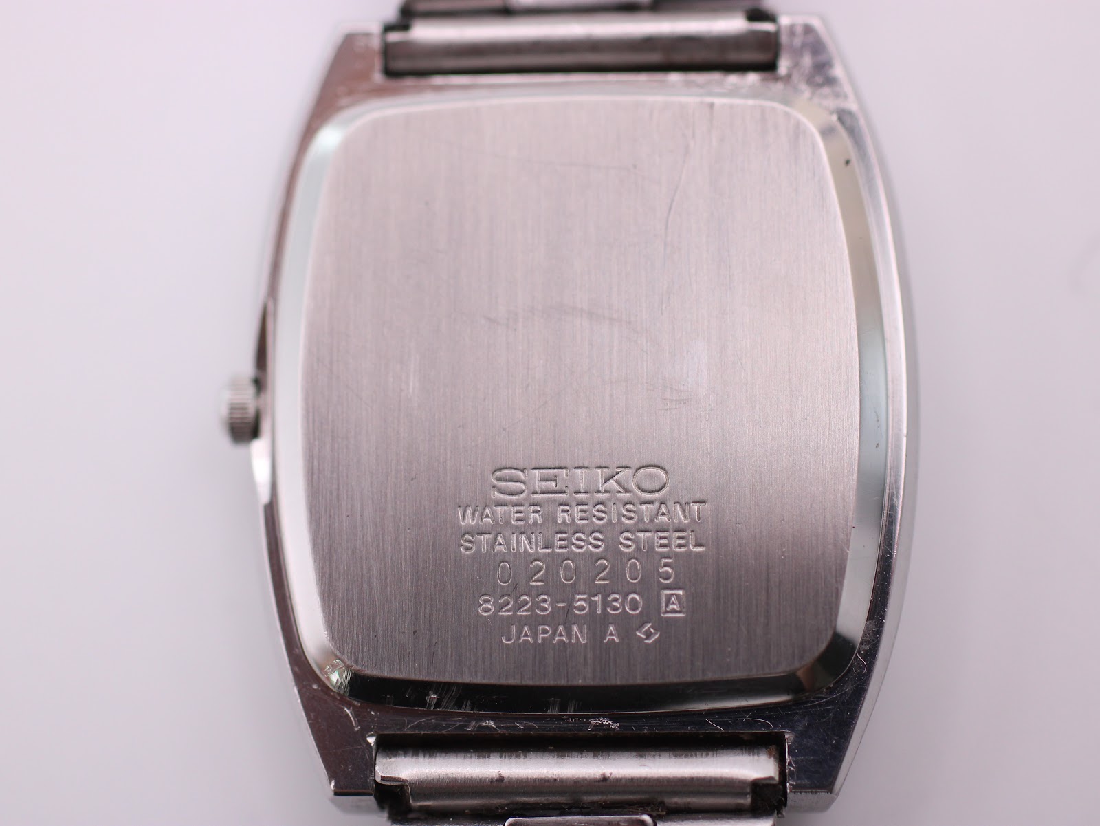 Case back of the Seiko watch, engraved with "WATER RESISTANT STAINLESS STEEL" and model/serial numbers 3223-5130.