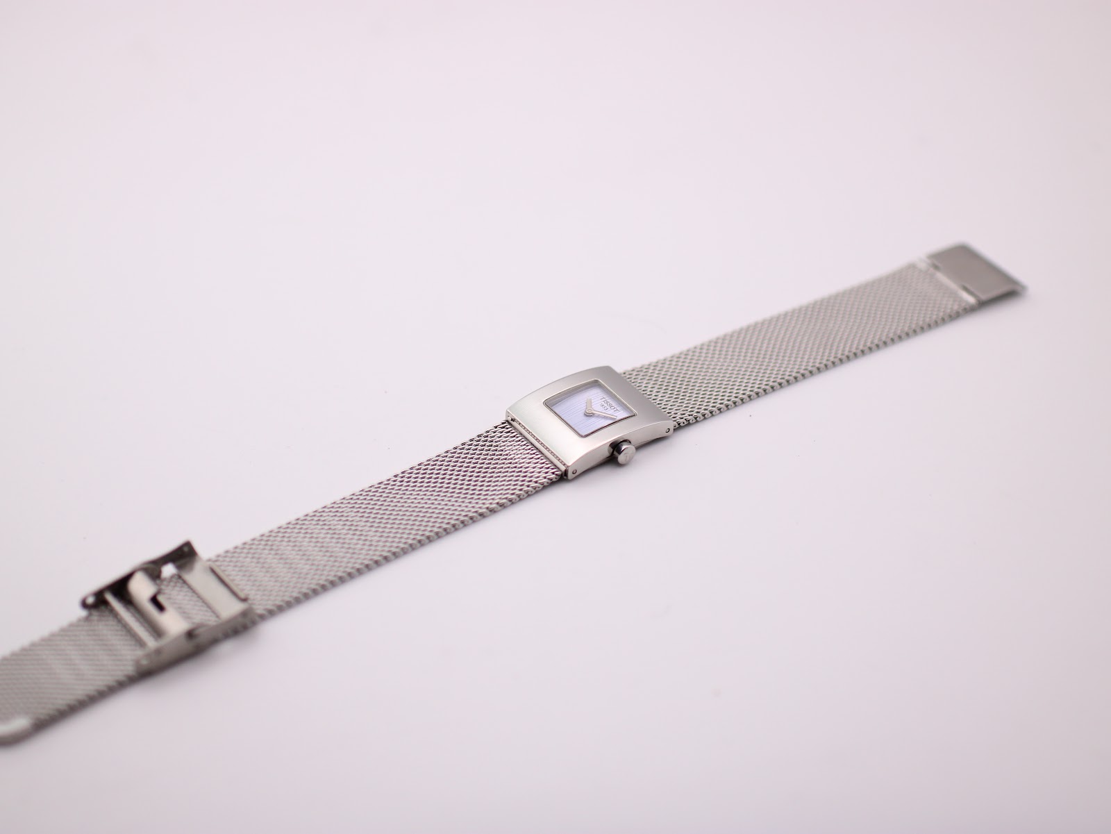 Full view of the Tissot L610K watch laid flat, showcasing the entire stainless steel mesh bracelet and clasp.