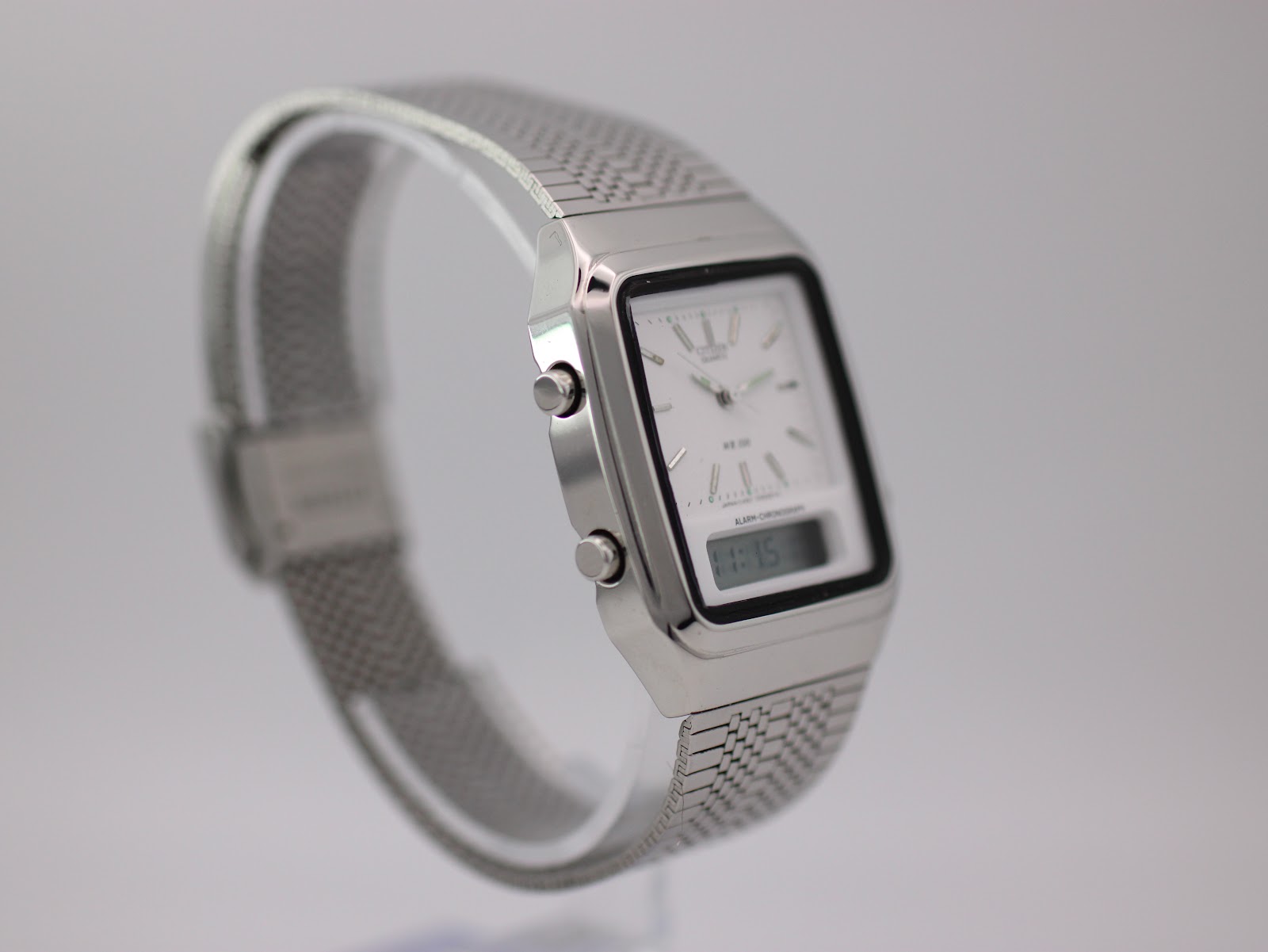 Left side profile view of the Citizen C480 ana-digi watch, highlighting the case lines and integrated mesh bracelet.