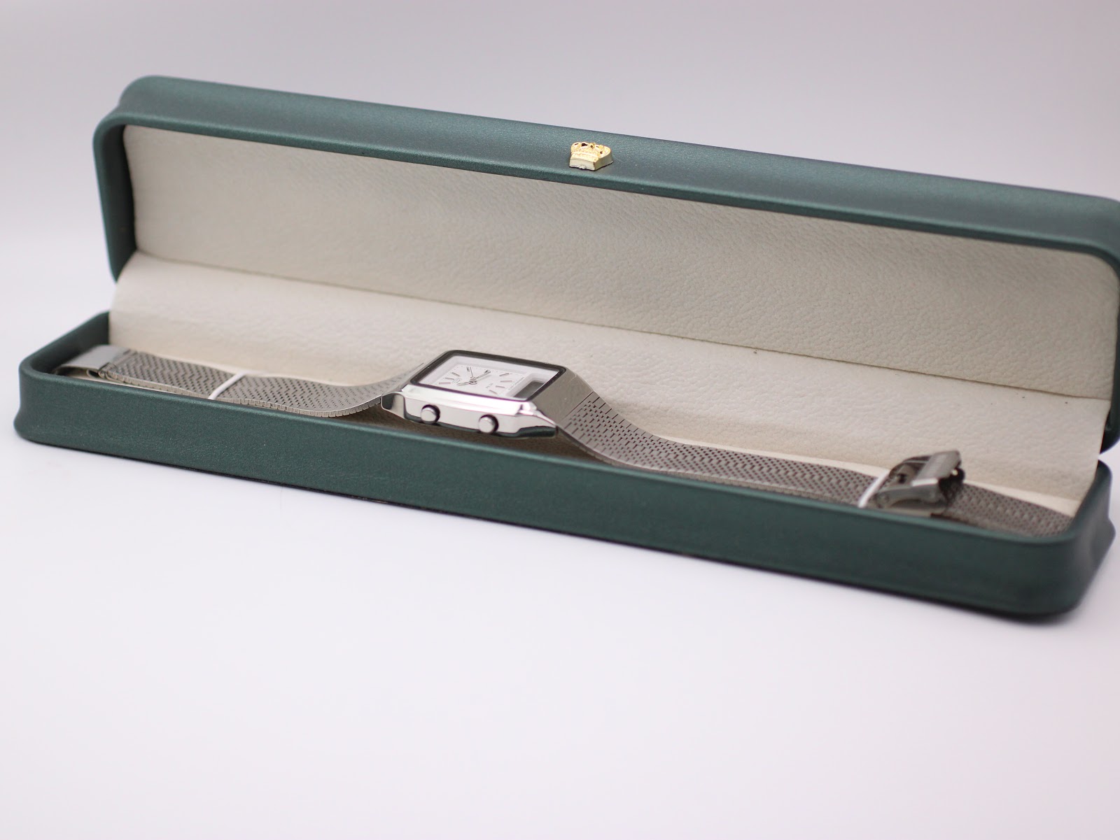 The Citizen C480 watch laid out inside a green leatherette display box with a small gold crown emblem.