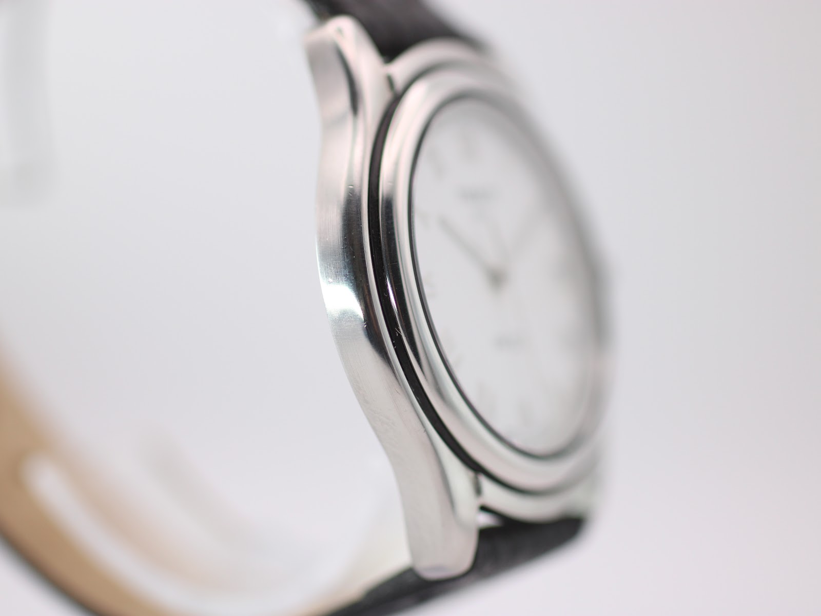 Side view of Tissot PR 50 watch, showing the sleek profile of the silver stainless steel case.