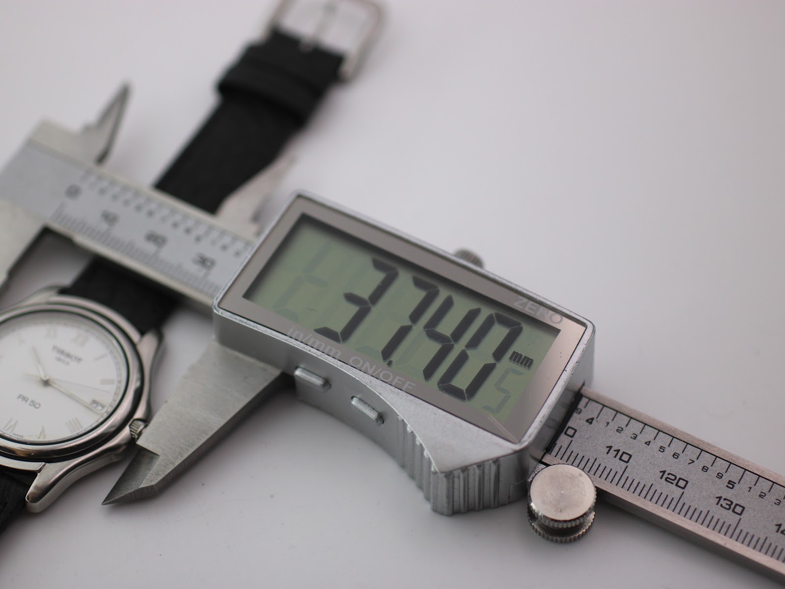 Digital caliper measuring the Tissot PR 50 case diameter at 37.40mm.
