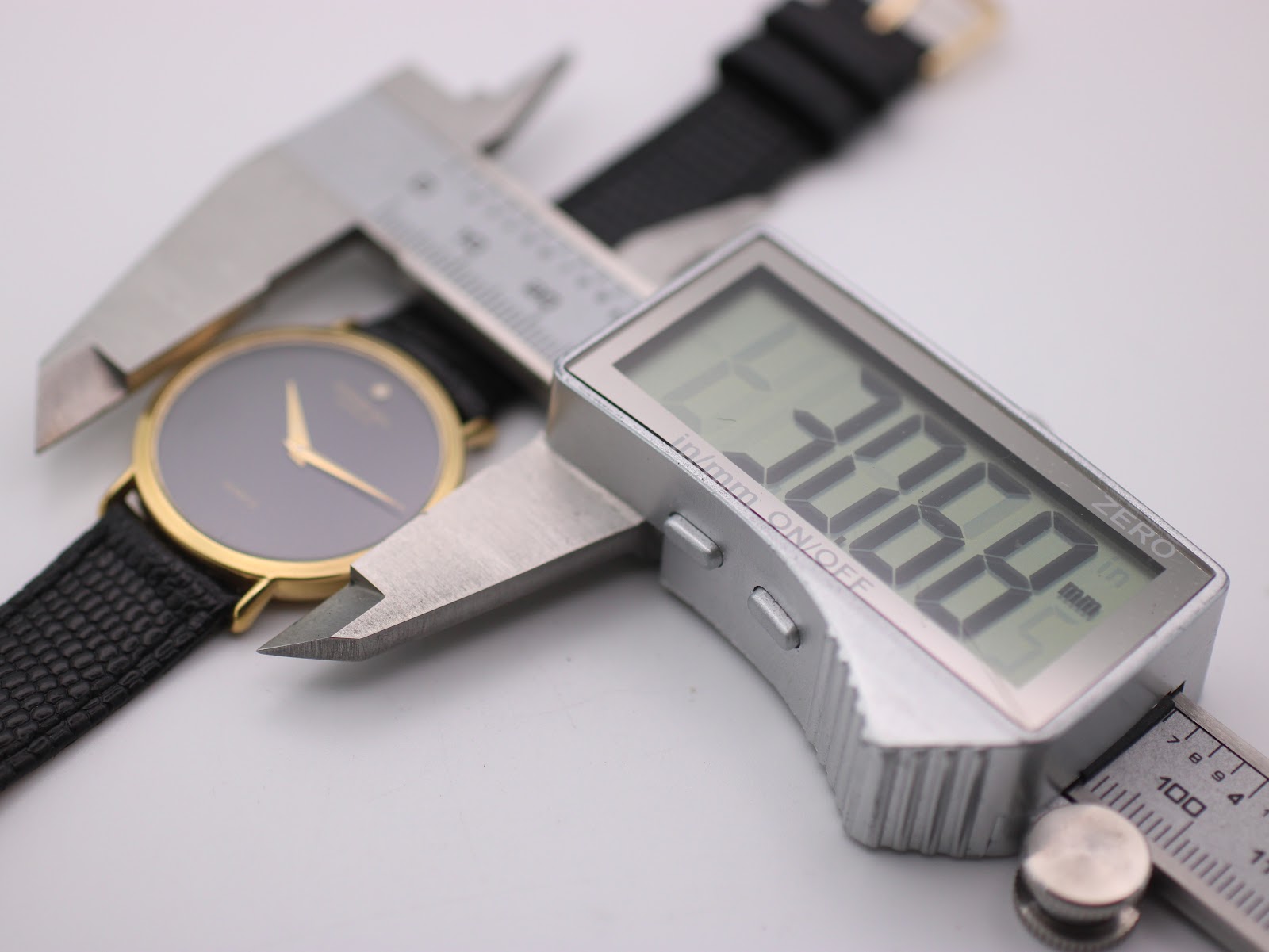 Digital caliper measuring the case diameter of the watch, showing a precise reading of 30.68mm.