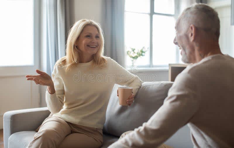 couple having honest conversation living room natural light candid
