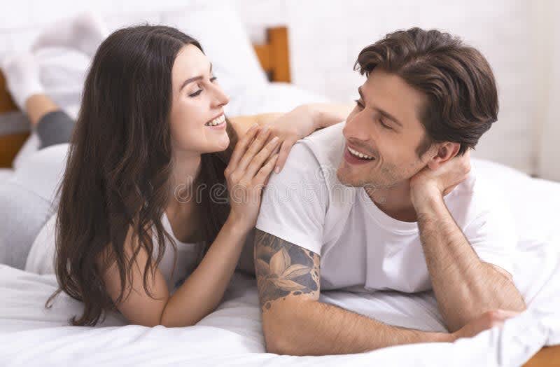 relaxed couple bedroom warm lighting intimate conversation