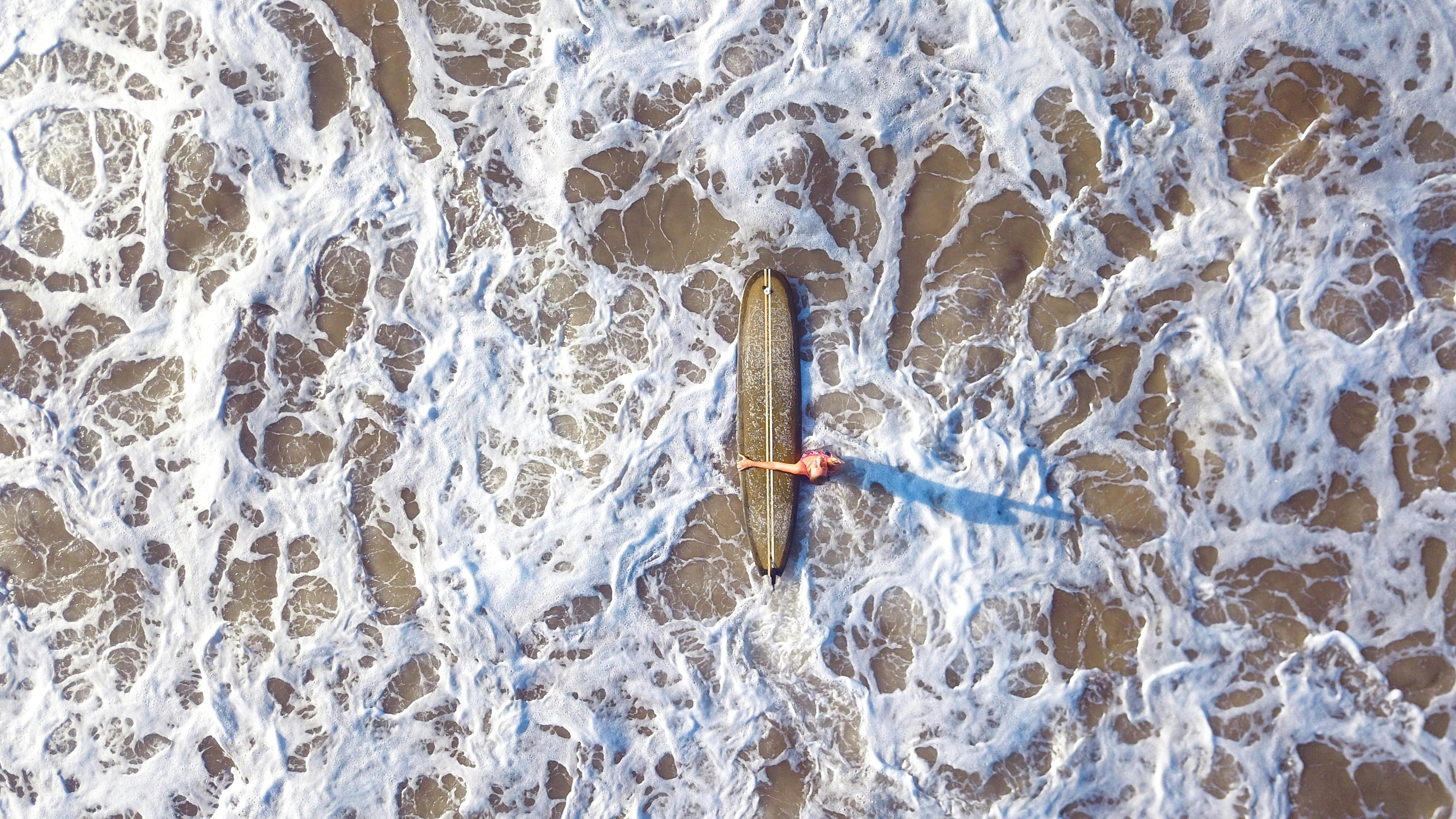 Surfer holding surfboard in Mirissa