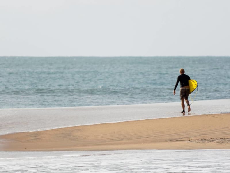 Surfer at the beach in Pottuvil Point