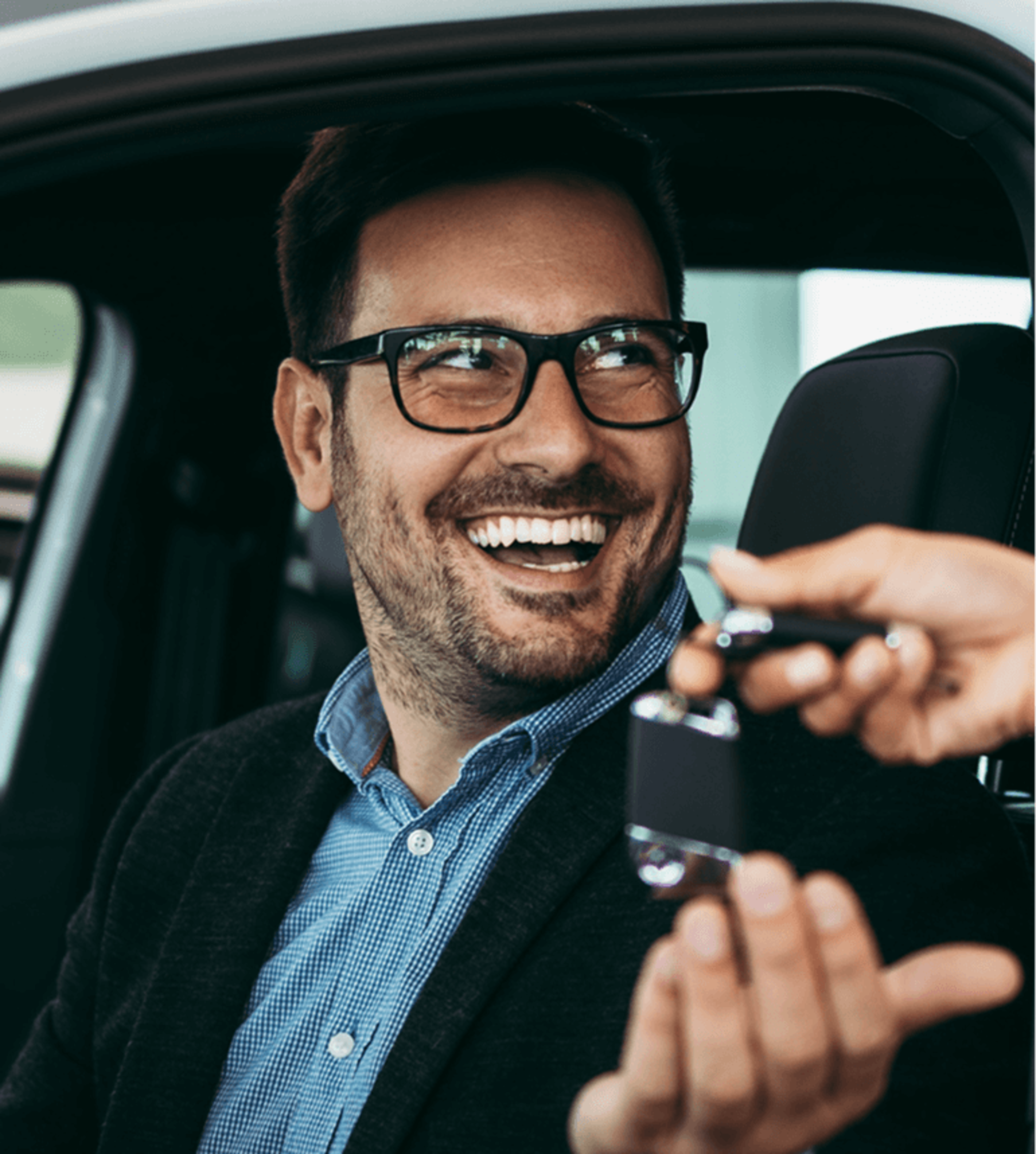 A person receiving keys from isnide a car