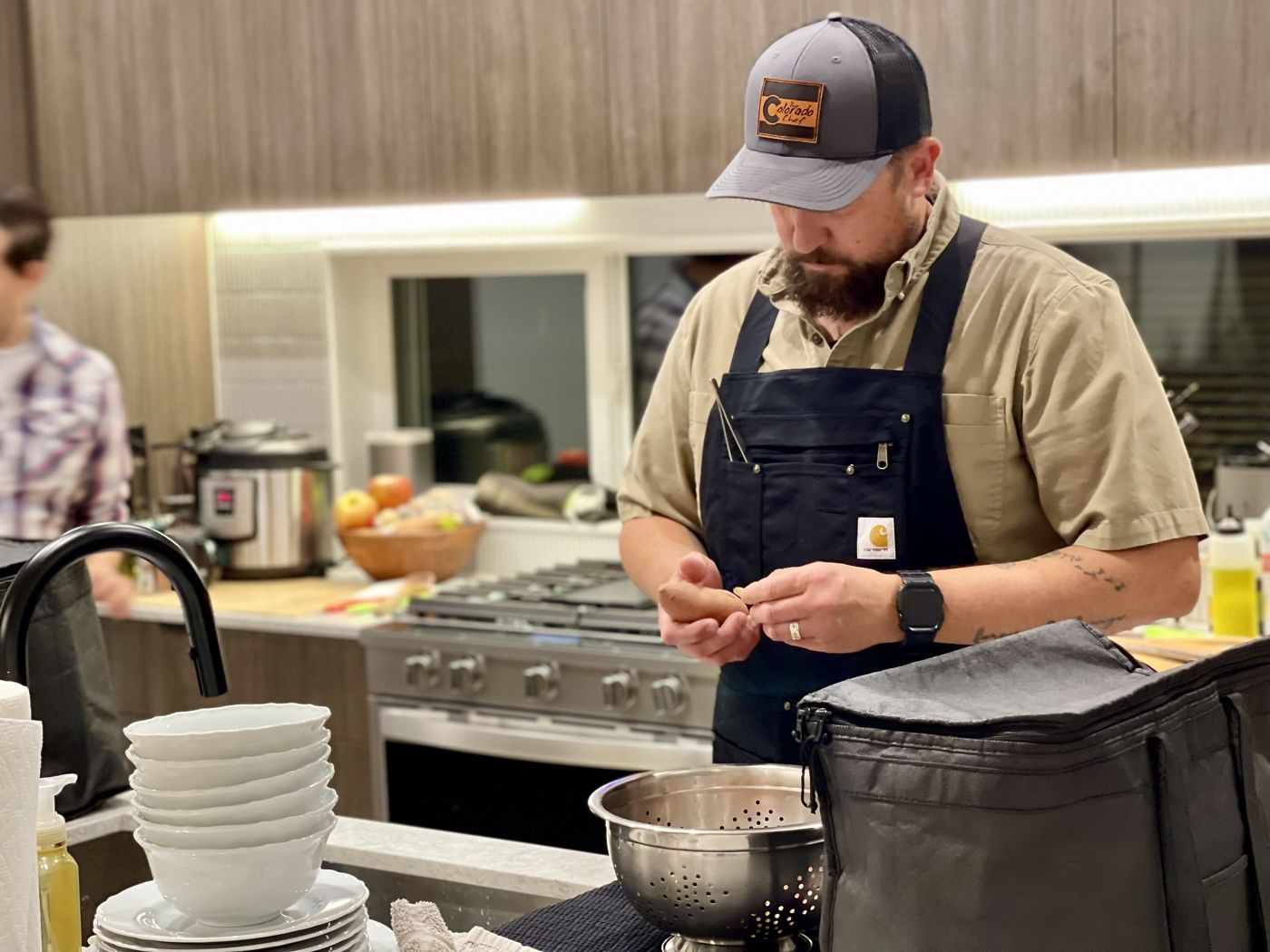 A private chef cooking a holiday dinner in a client's home kitchen in Denver