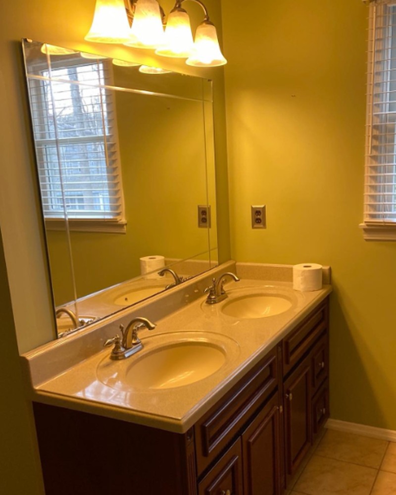 Single vanity with yellow walls before the remodel