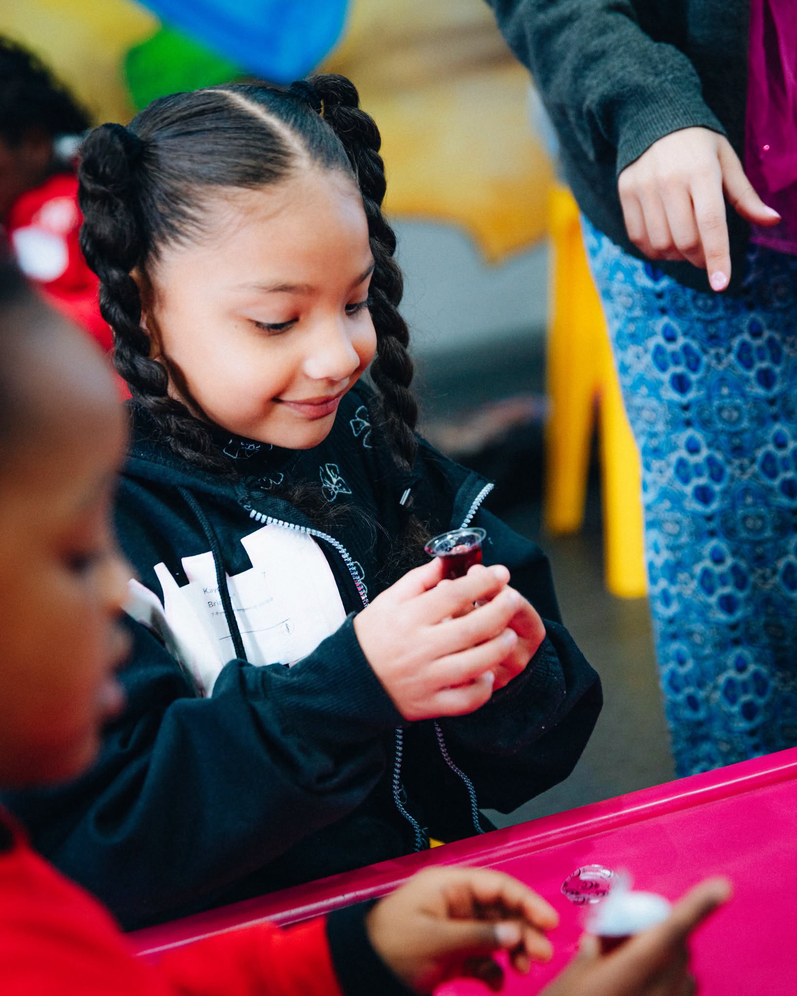 Children playing on spring riders at the NBCFC Kids outdoor play area
