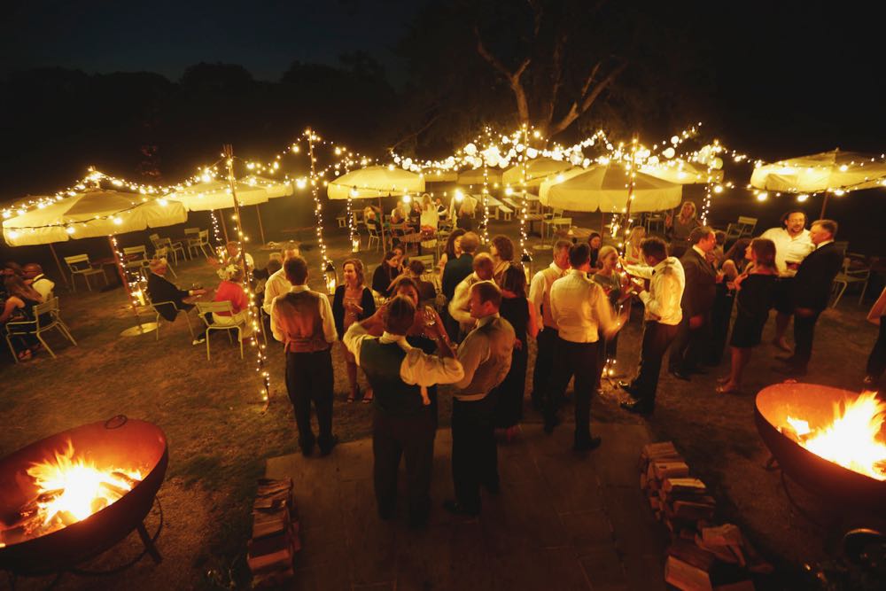 Free-standing lighting canopy with tree lighting in the distance, versatile wedding and event lighting design