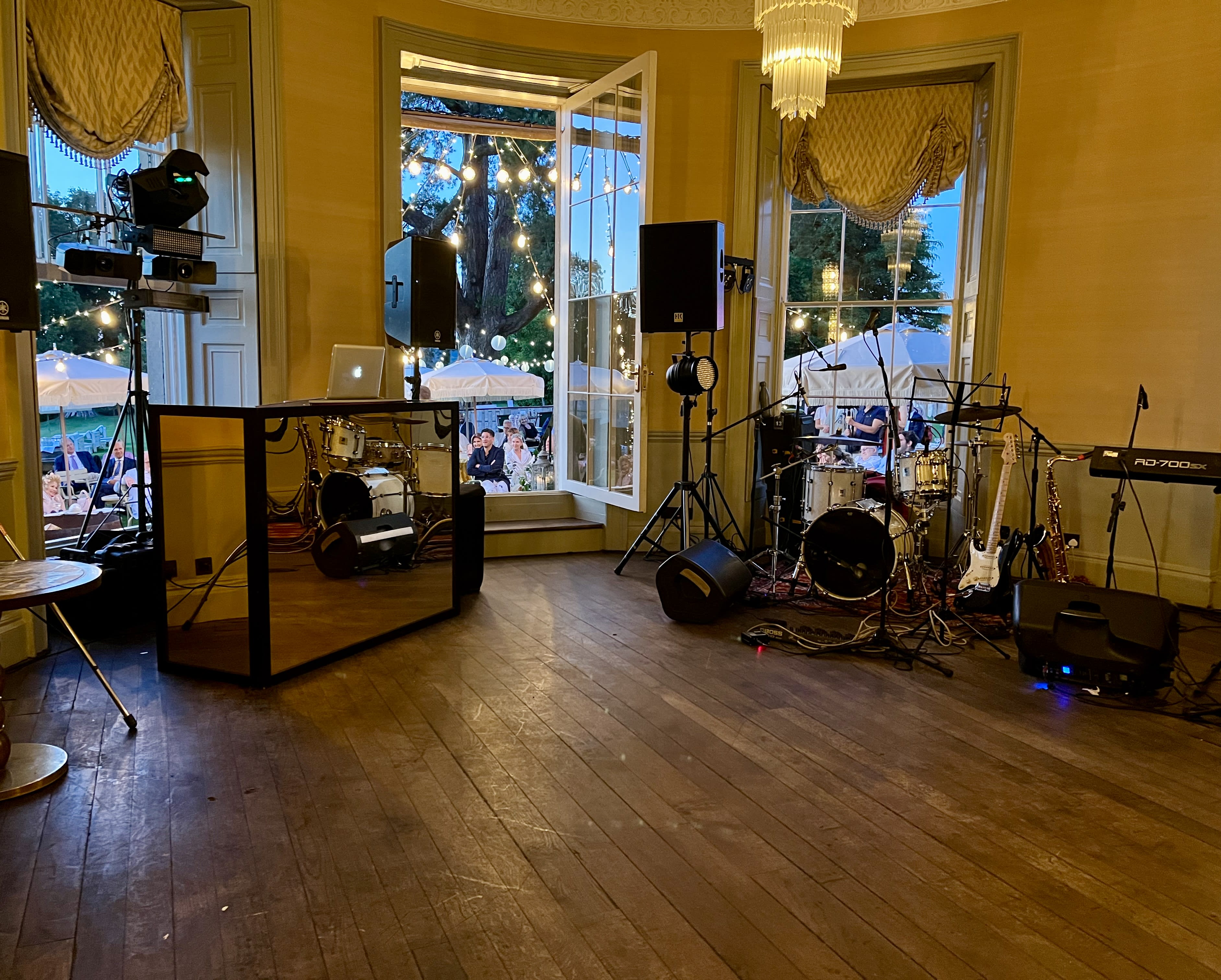 Babington House bar with DJ and band setup in summer