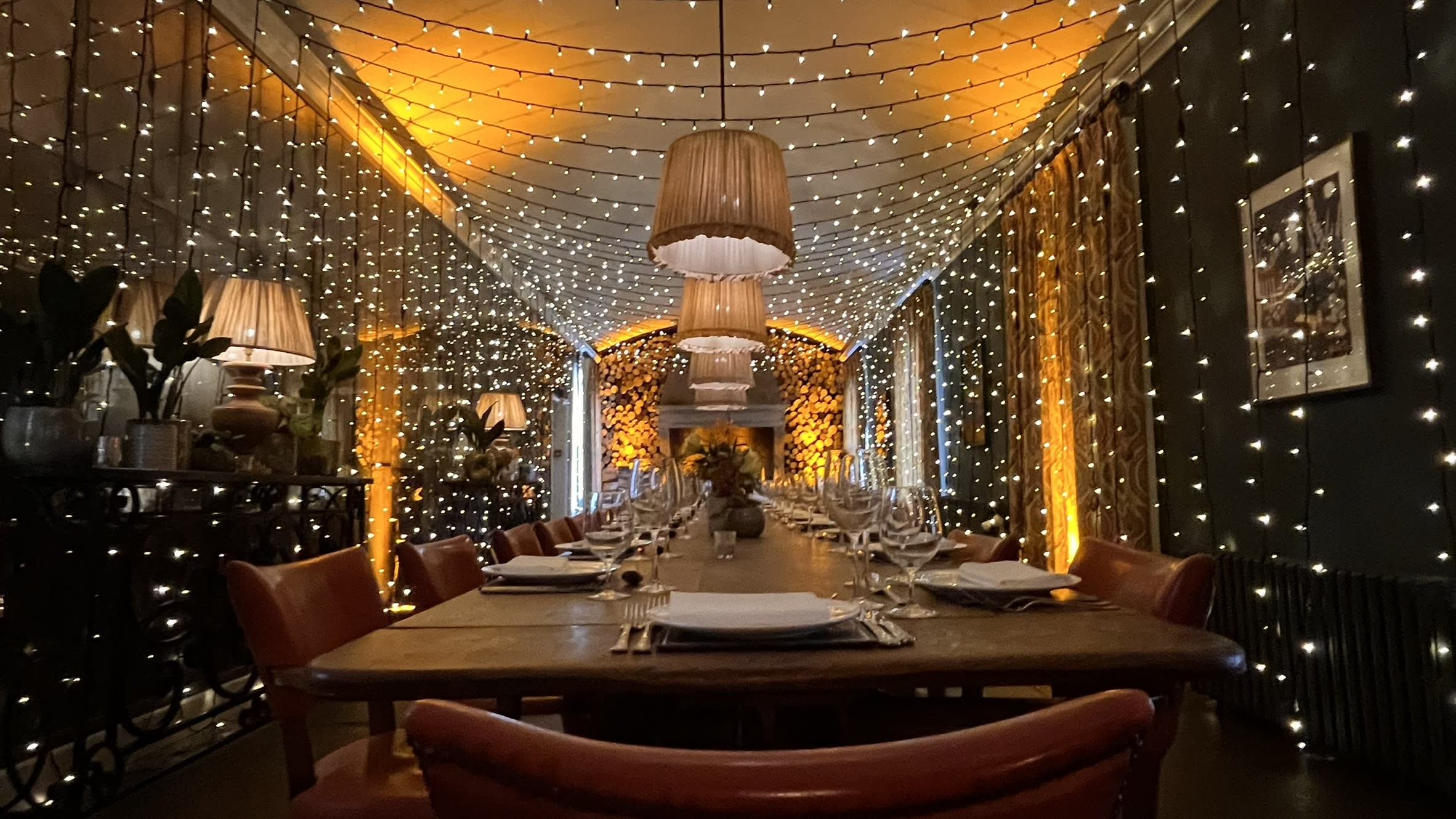 Enchanting fairy light tunnel at Babington House showcasing our professional wedding services