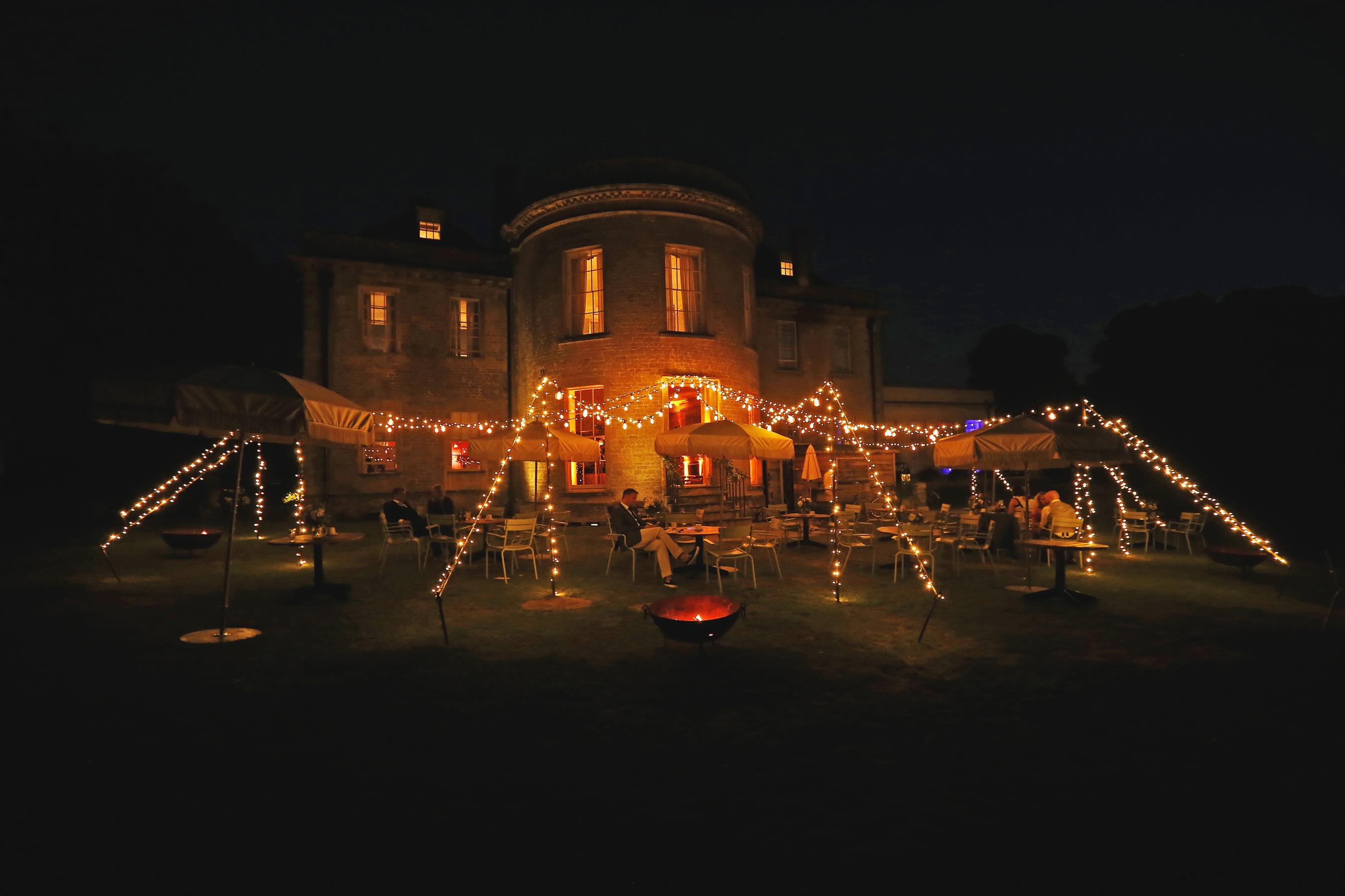 Chill Out Camp with vintage Edison festoon lighting and fairy lights creating a magical wedding atmosphere
