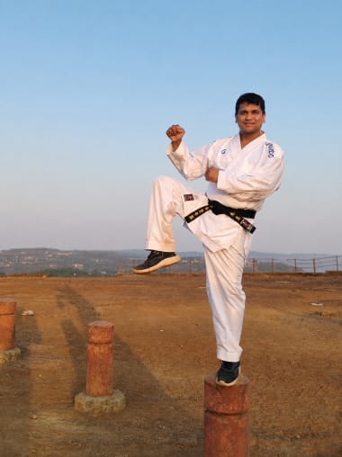 Student practicing high-focus kata forms in a dojo setting