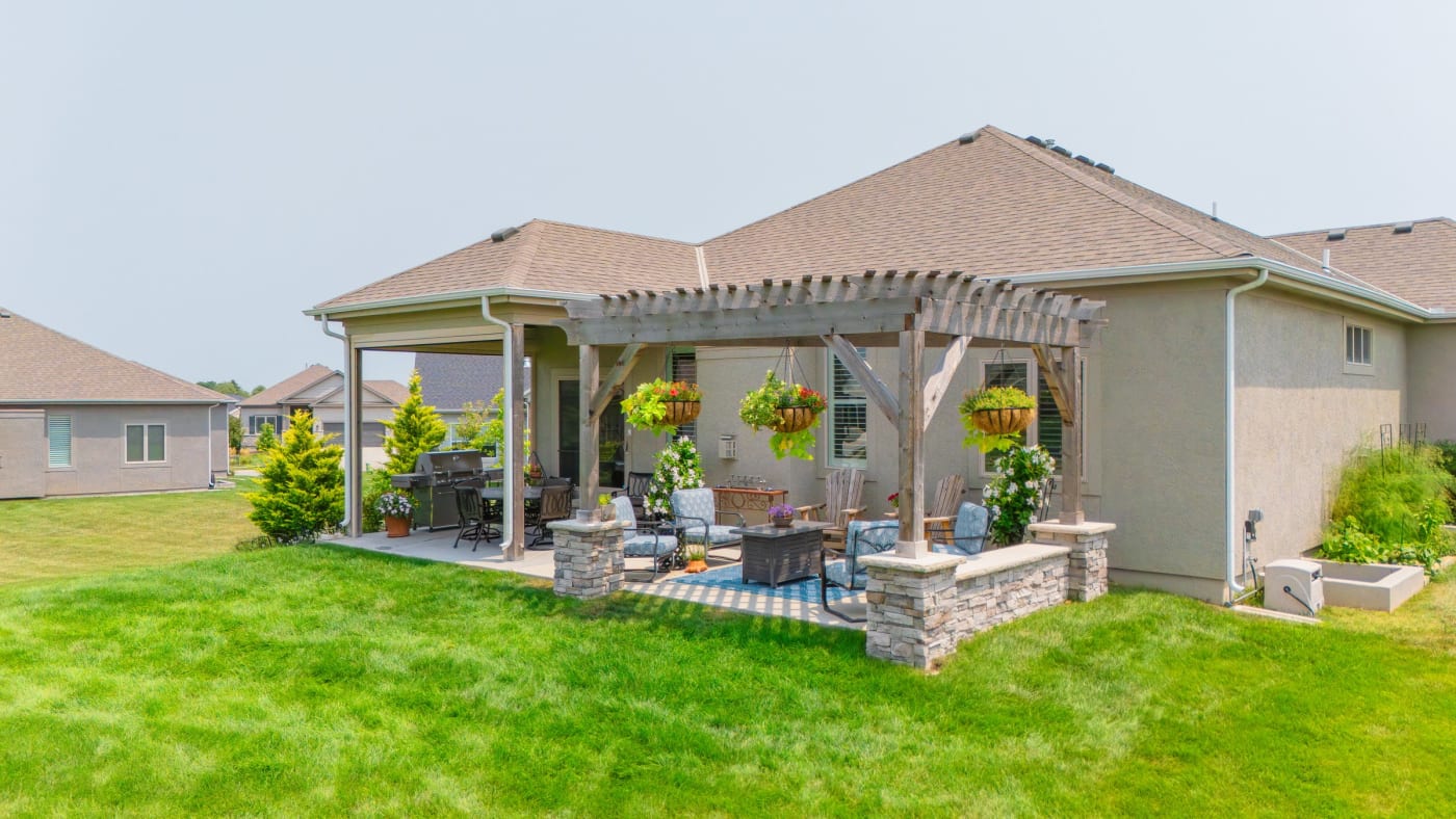 Pergola, concrete patio, and retaining wall in Olathe, KS