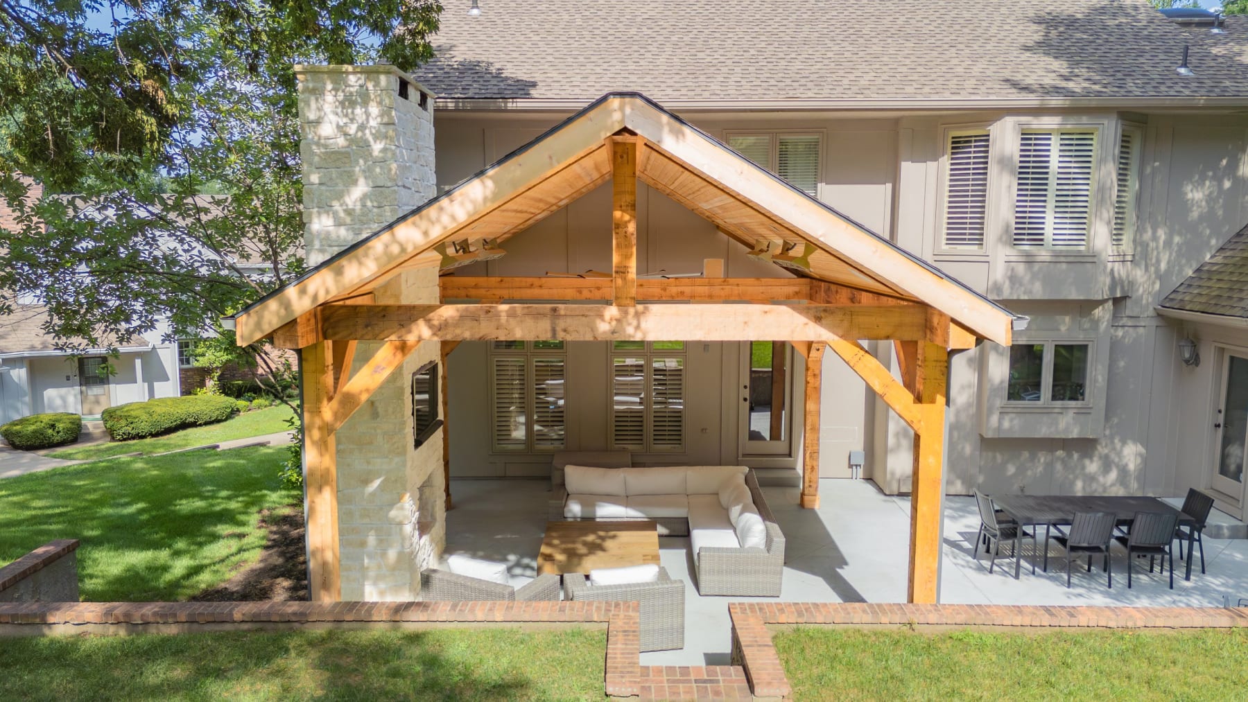 Outdoor living build with pavilion, paver patio, and fireplace by Kansas City Hardscapes