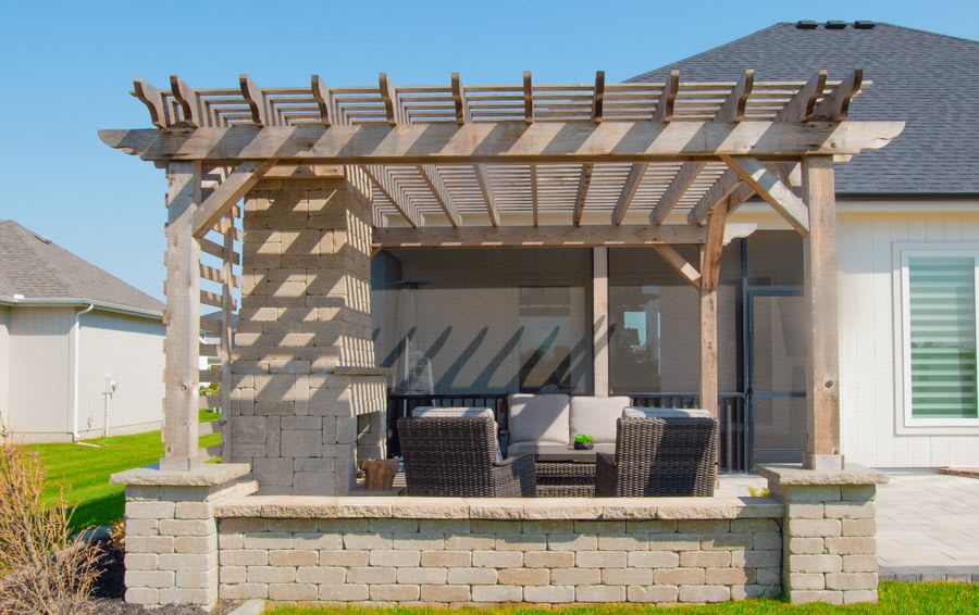 Cedar pergola on stone-base patio
