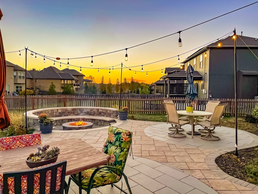 A sunken wood burning fire pit built into a paver patio in Kansas City, Missouri