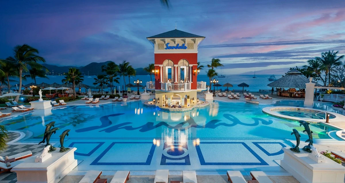 Sandals Grande St Lucian main pool bar night.webp