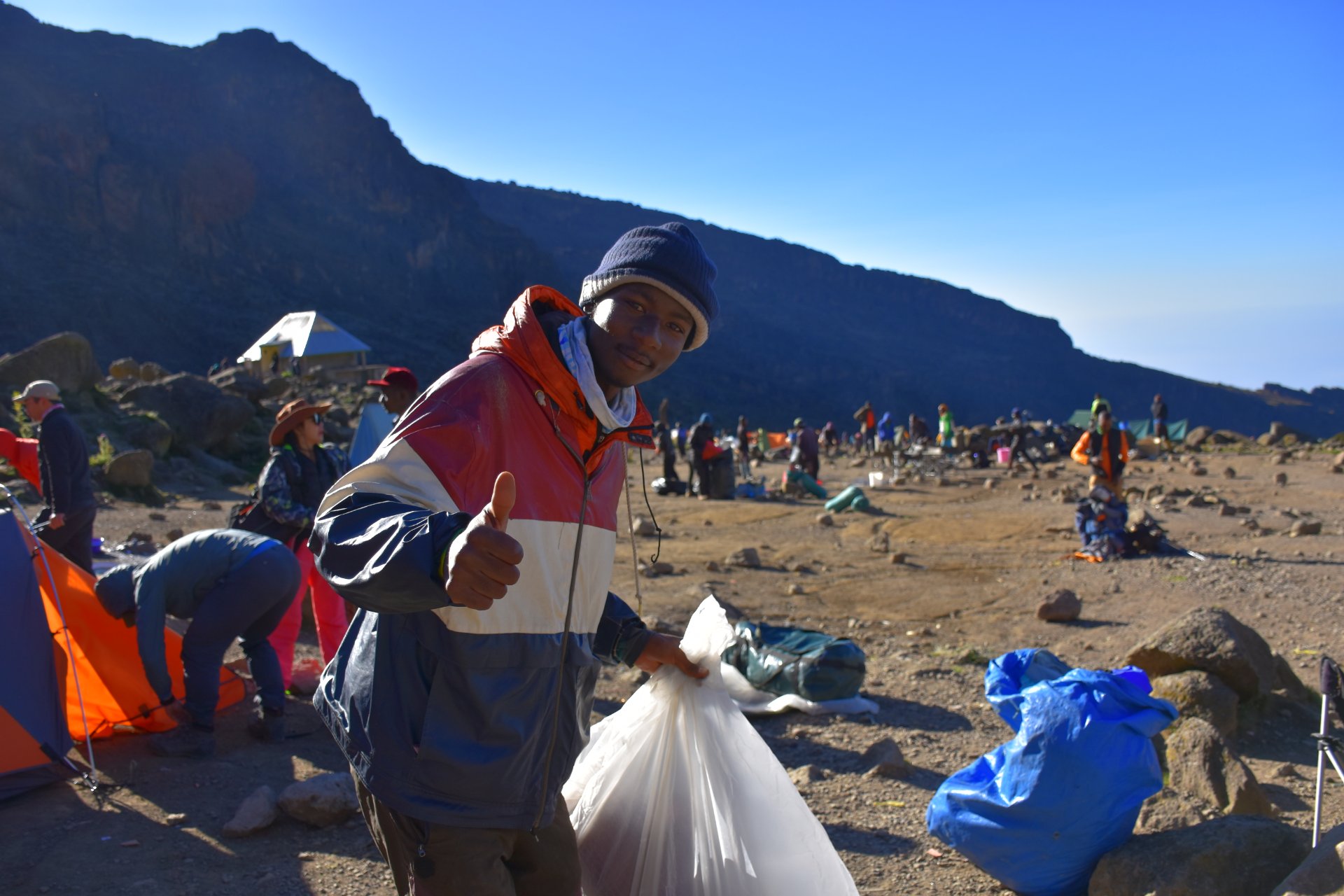 Kilimanjaro porters hiking with climbers at sunrise